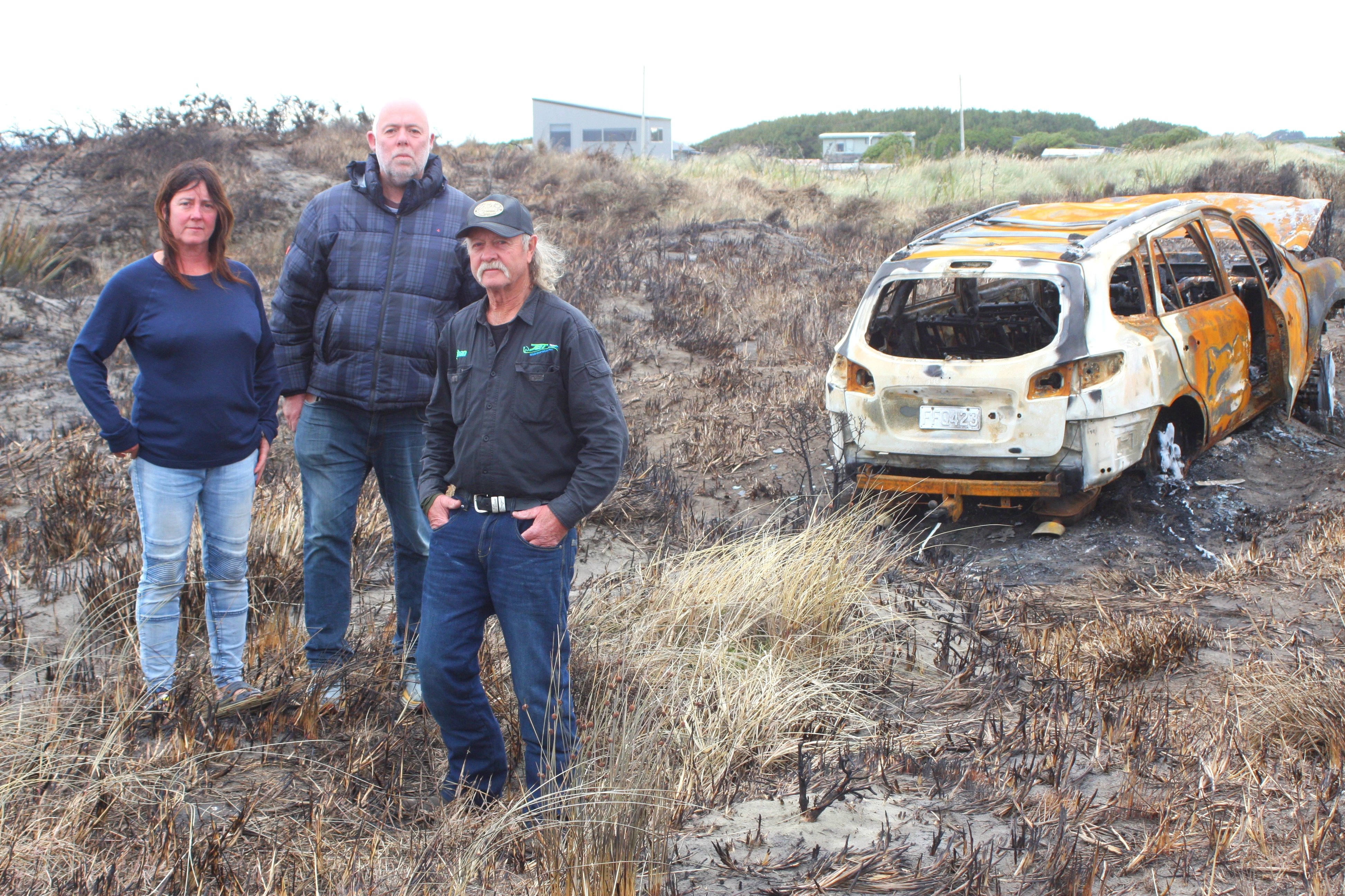 Oki St, Oreti Beach residents (from left) Joyce Kolk, Gavin Booth and Johan Groters stand next to...