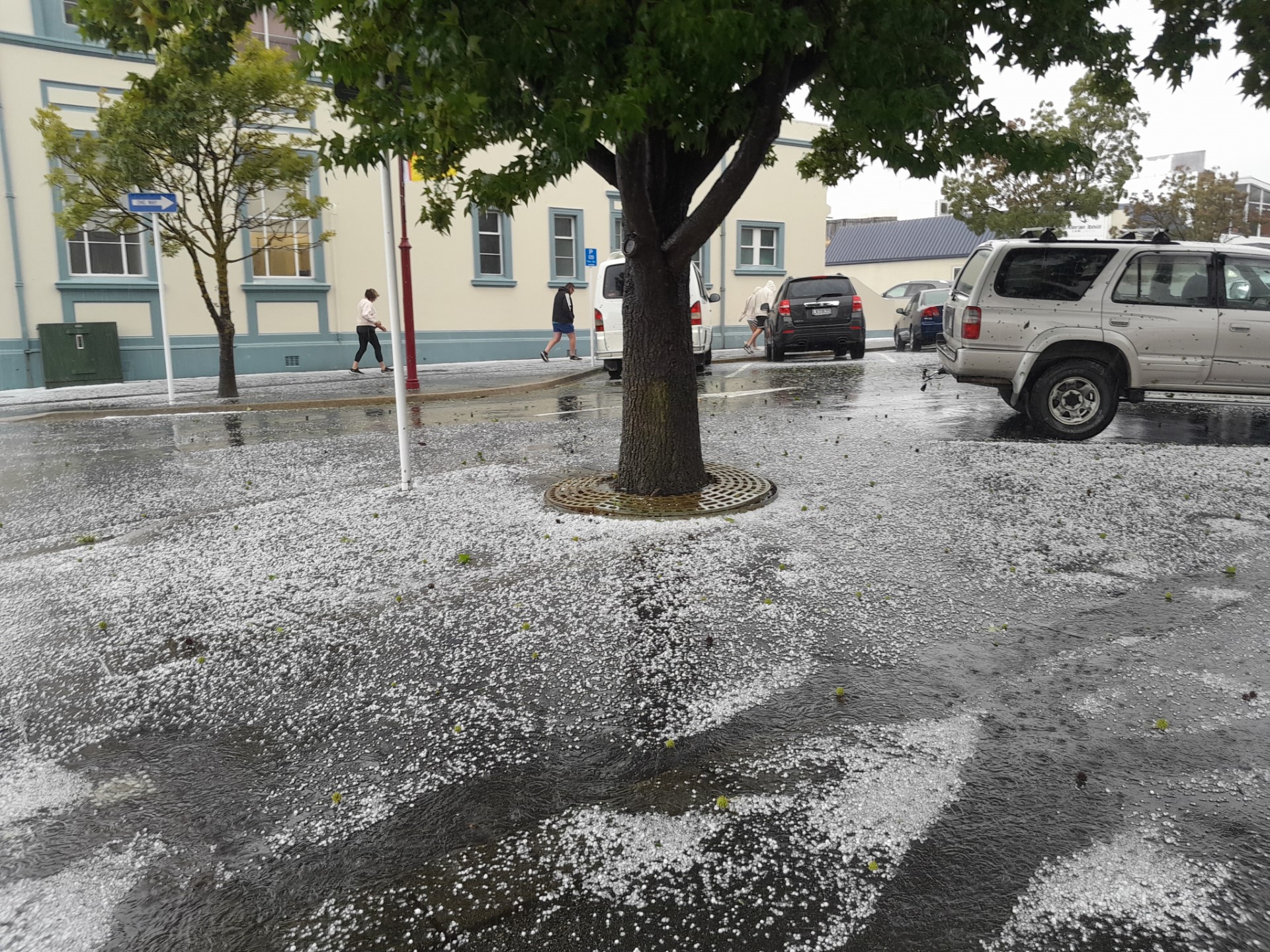 Pedestrians watch where they walk in Skird St after a hailstorm this afternoon. Photo: Ruby Shaw