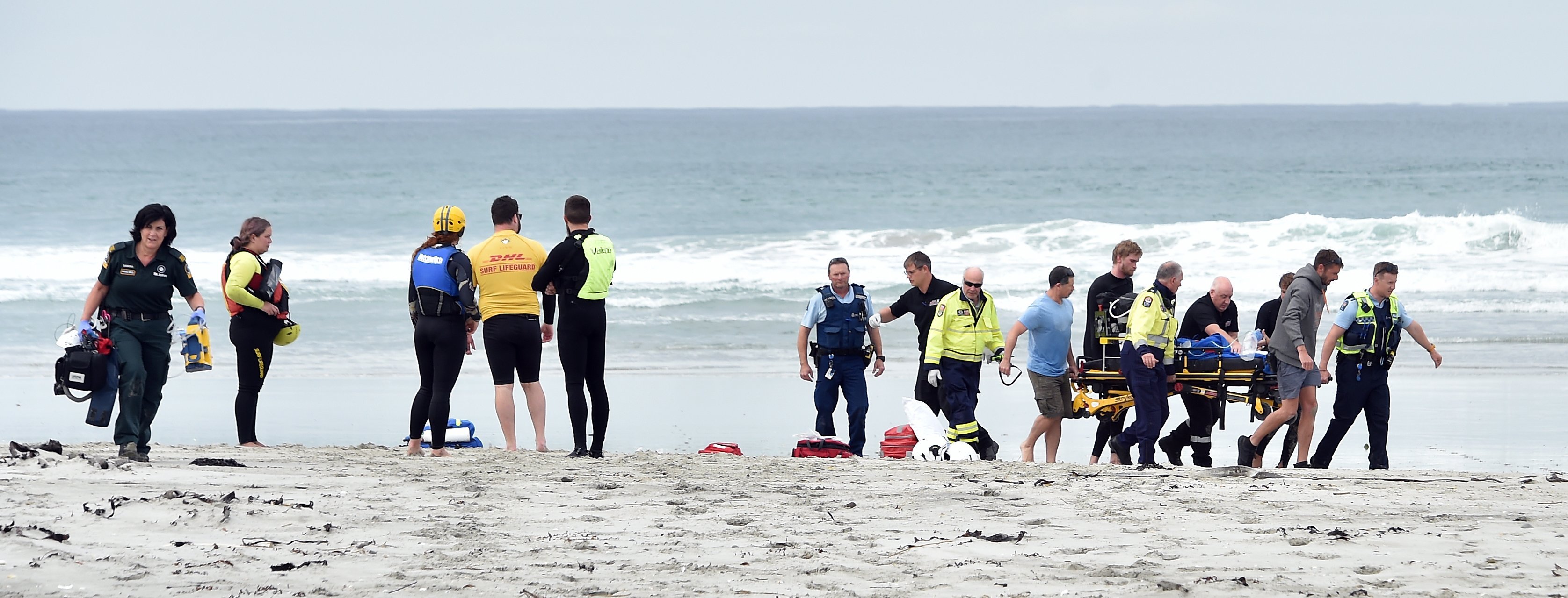 Emergency services carry a patient following the boat capsize in Taieri Mouth that claimed the...