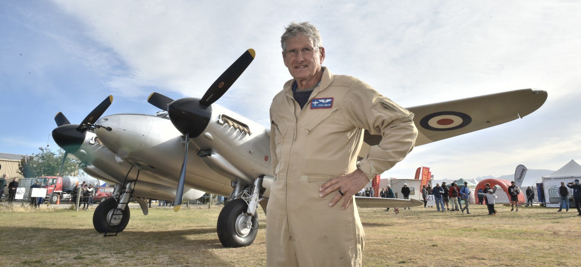 Pilot Steve Hinton, of the United States, stands in front of a newly restored Mosquito de...