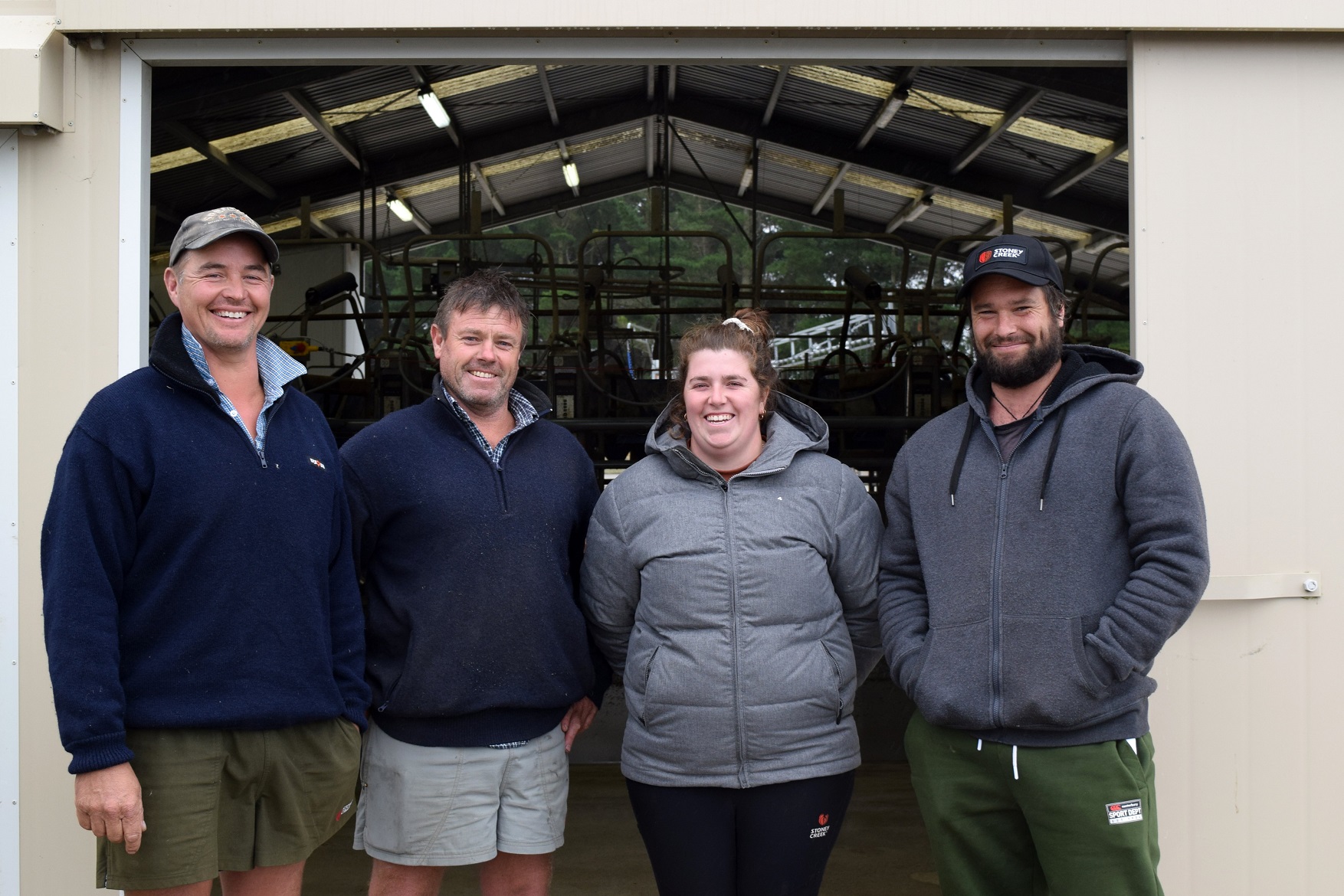 Outside the milking shed at a dairy farm in Kuriwao are (from left) retiring contract milker...