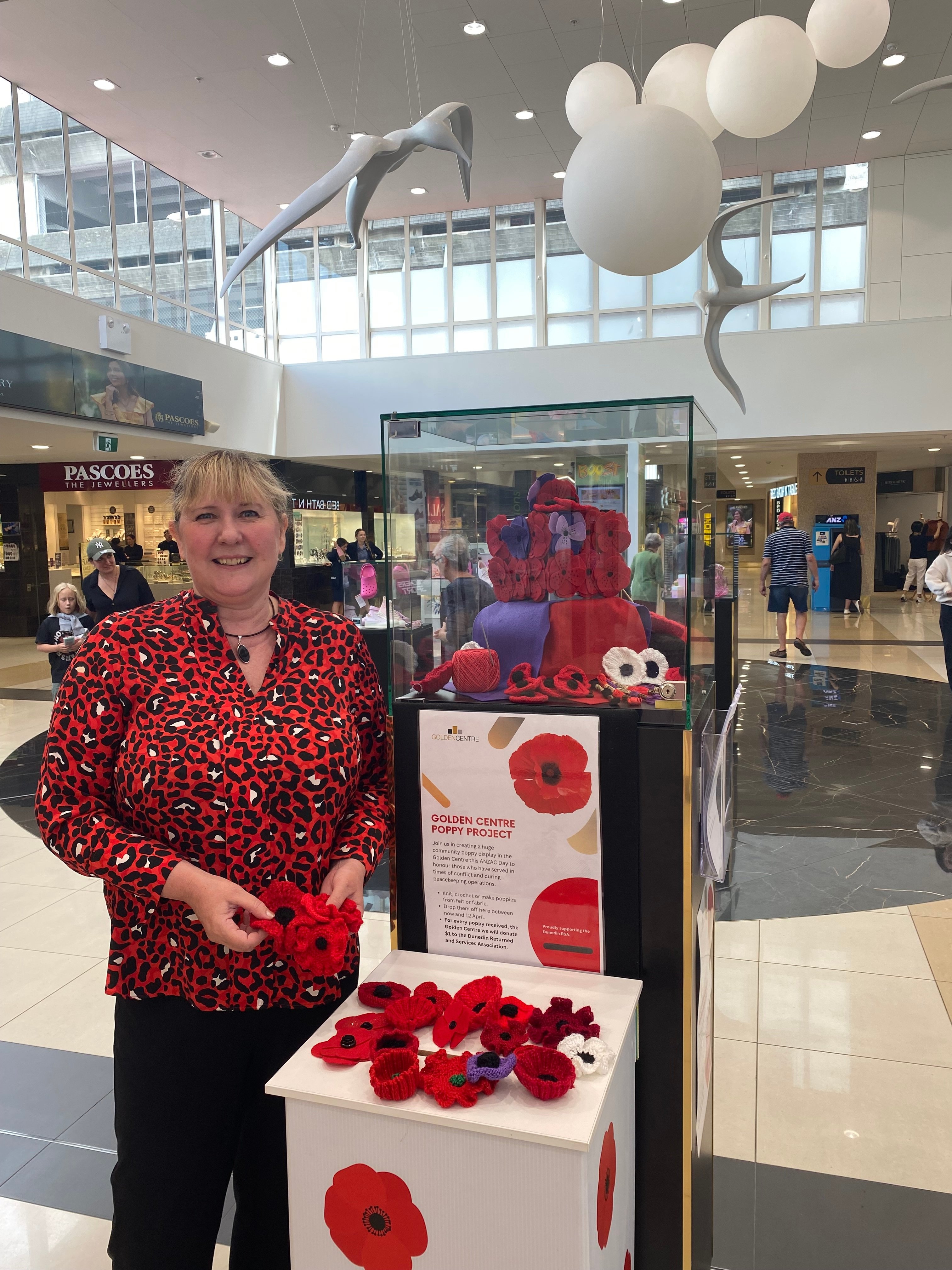 Golden Centre manager Nina Rivett holds some of the hundreds of hand-made poppies, created by...