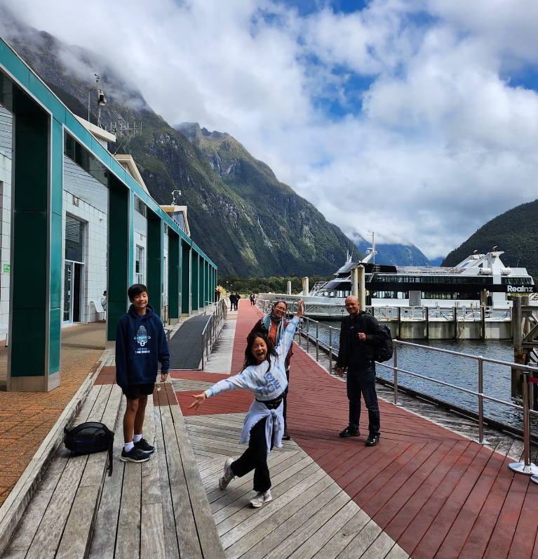 Tegan Chen strikes a pose with her family at Milford Sound. Photo: supplied