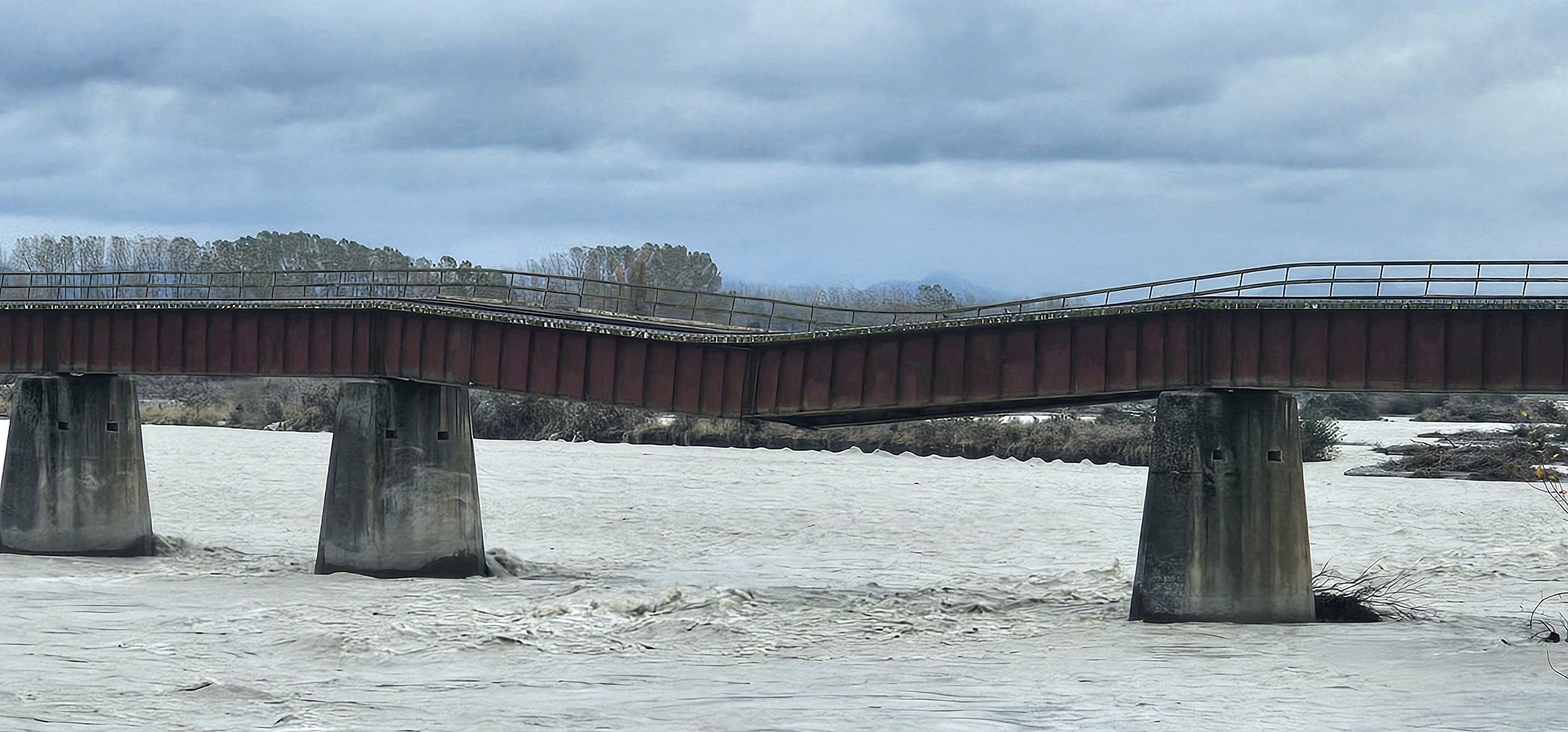 A 610m-long rail bridge over the Rangitata River, South Canterbury, sags after flood water washed...