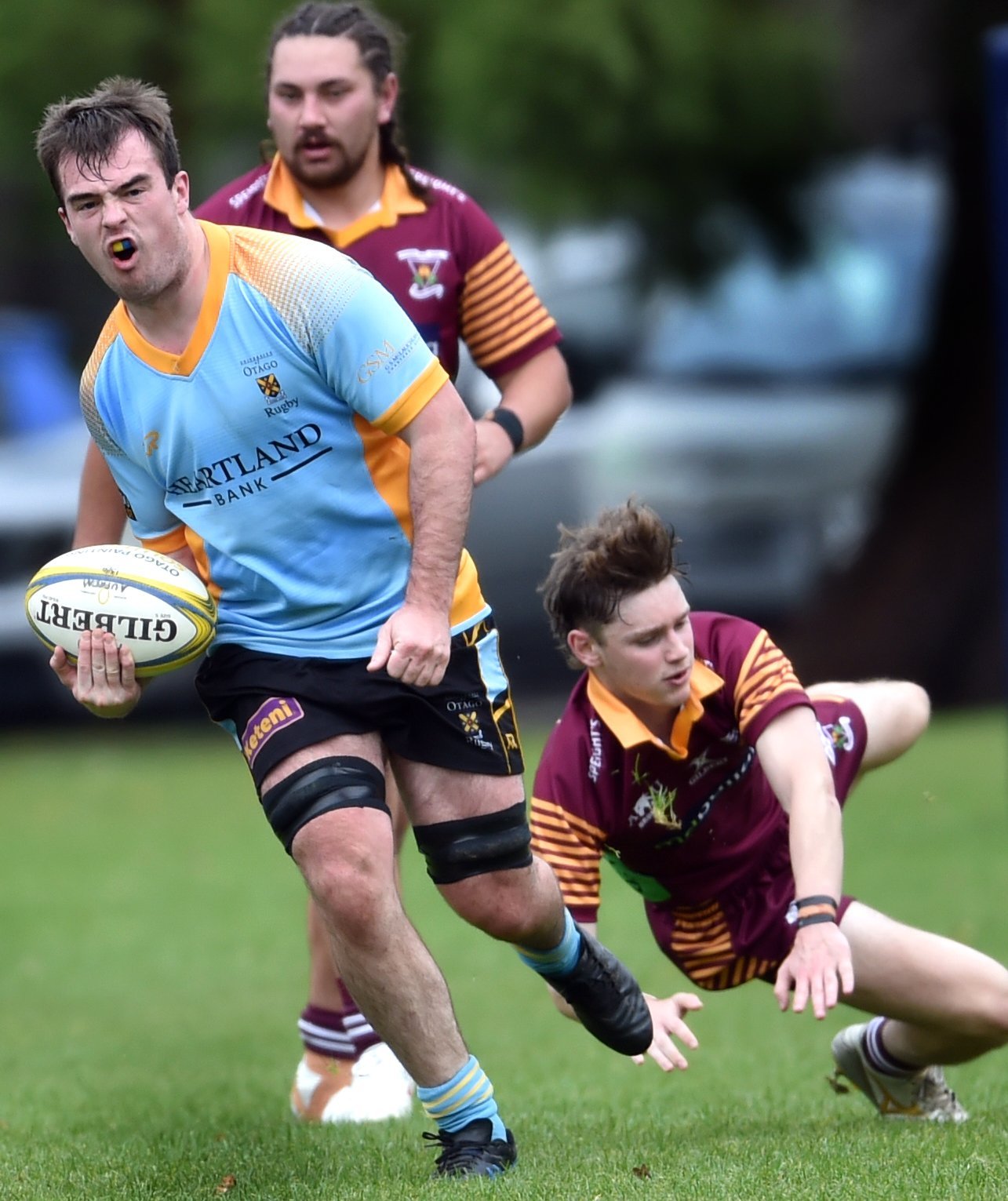 University flanker Oliver Geddes gets past Alhambra-Union defenders (from left) Jordan Gush and...