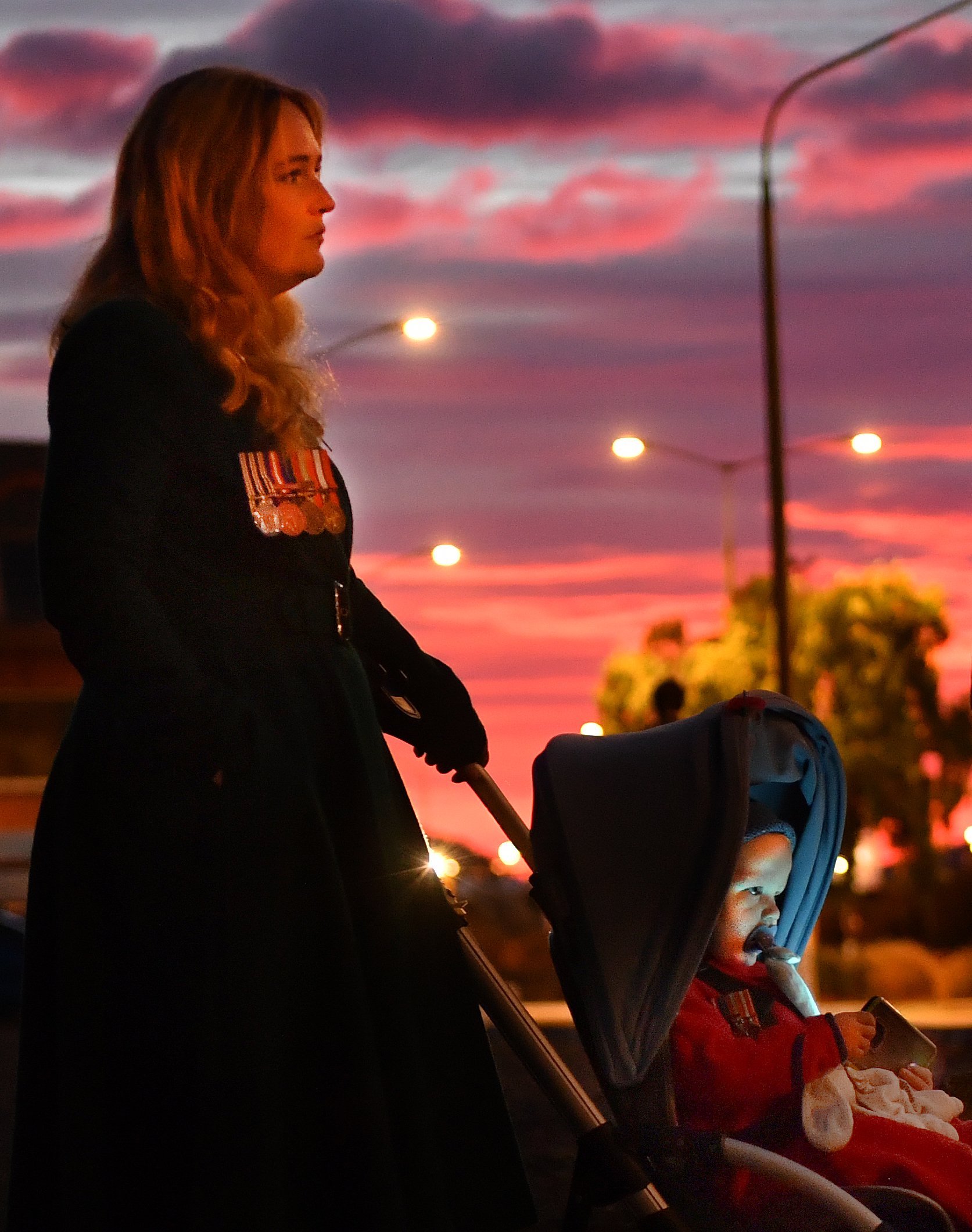 Teddy Baker, 1, looks up as LastPost is played at the Anzac dawn service at the cenotaph in...