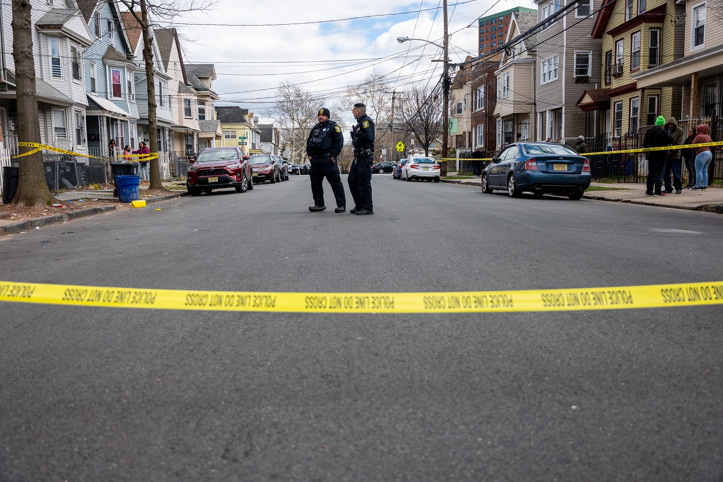 Residents and police gather outside of homes that were structurally damaged and had to be...