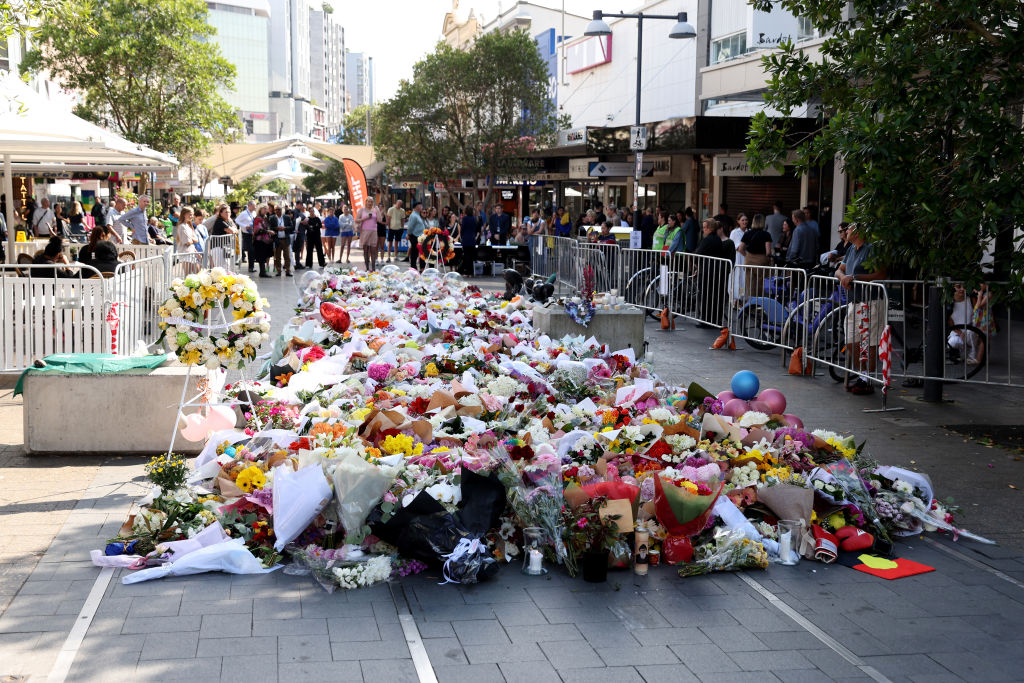 Flowers lie outside Sydney's Westfield Shopping mall in honour of the victims of the stabbing...