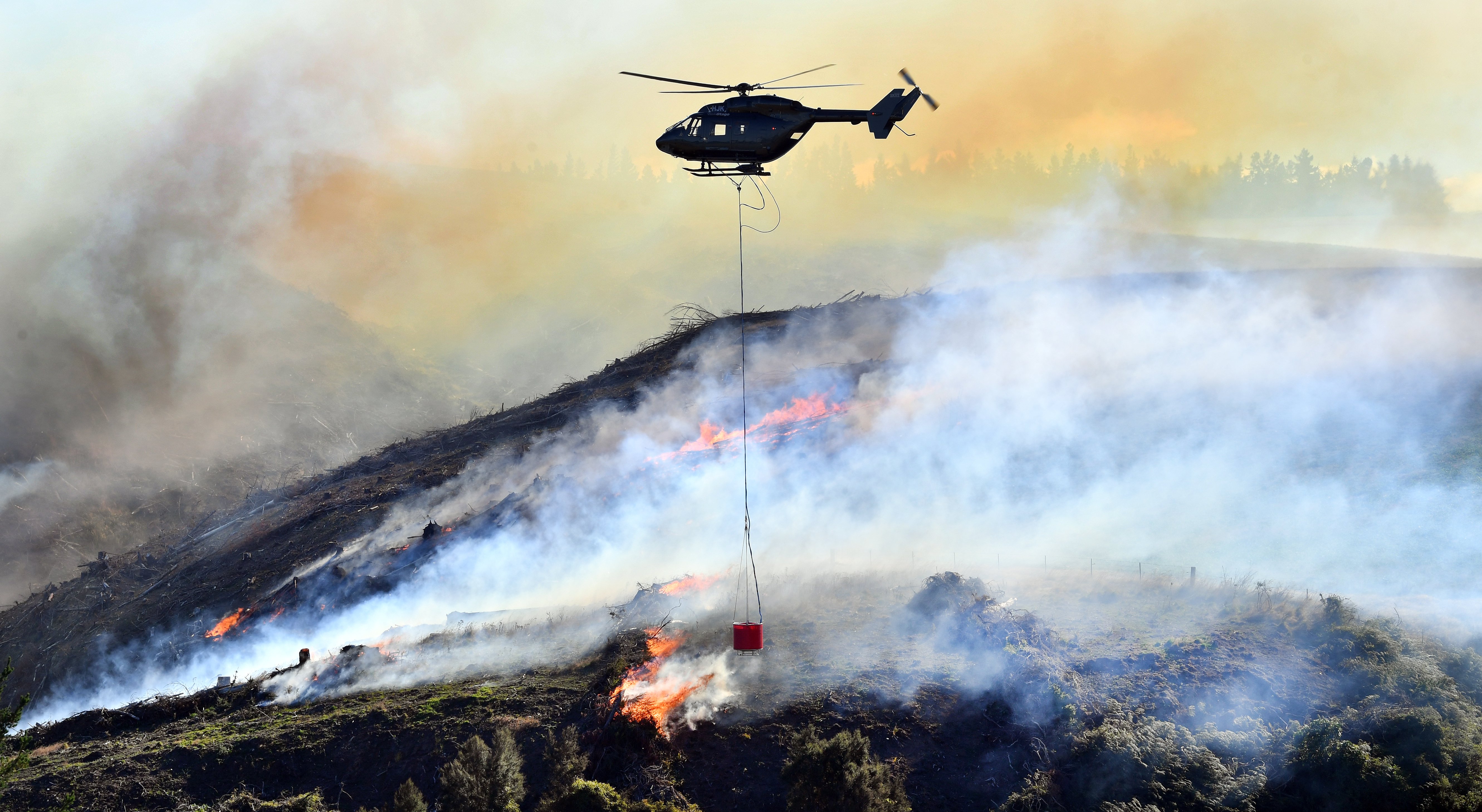 Helicopters with monsoon buckets were called in to fight a vegetation fire at Lee Stream, near...