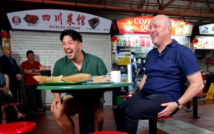 Prime Minister Christopher Luxon has a Singaporean street food breakfast with local social media...