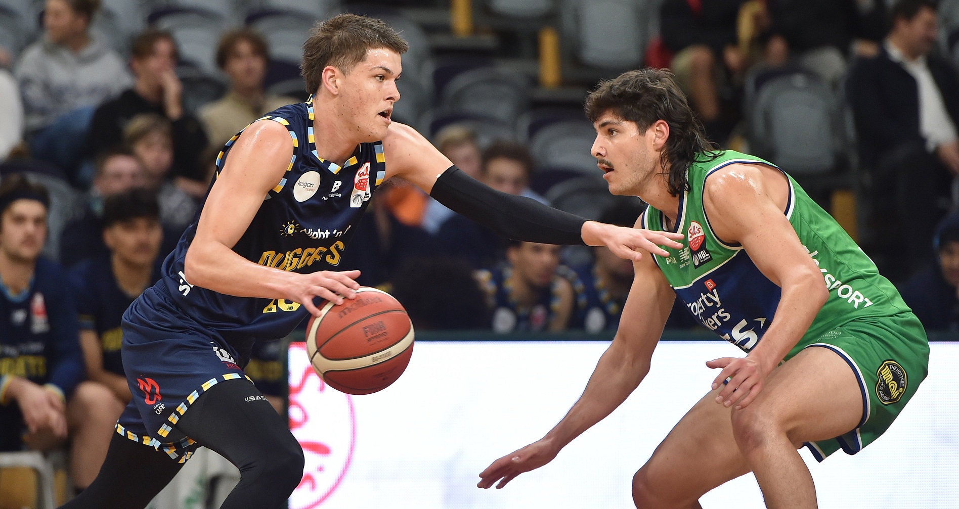 Ben Henshall, of the Otago Nuggets (left), tries to get past Manawatu Jets player Liam Judd in...