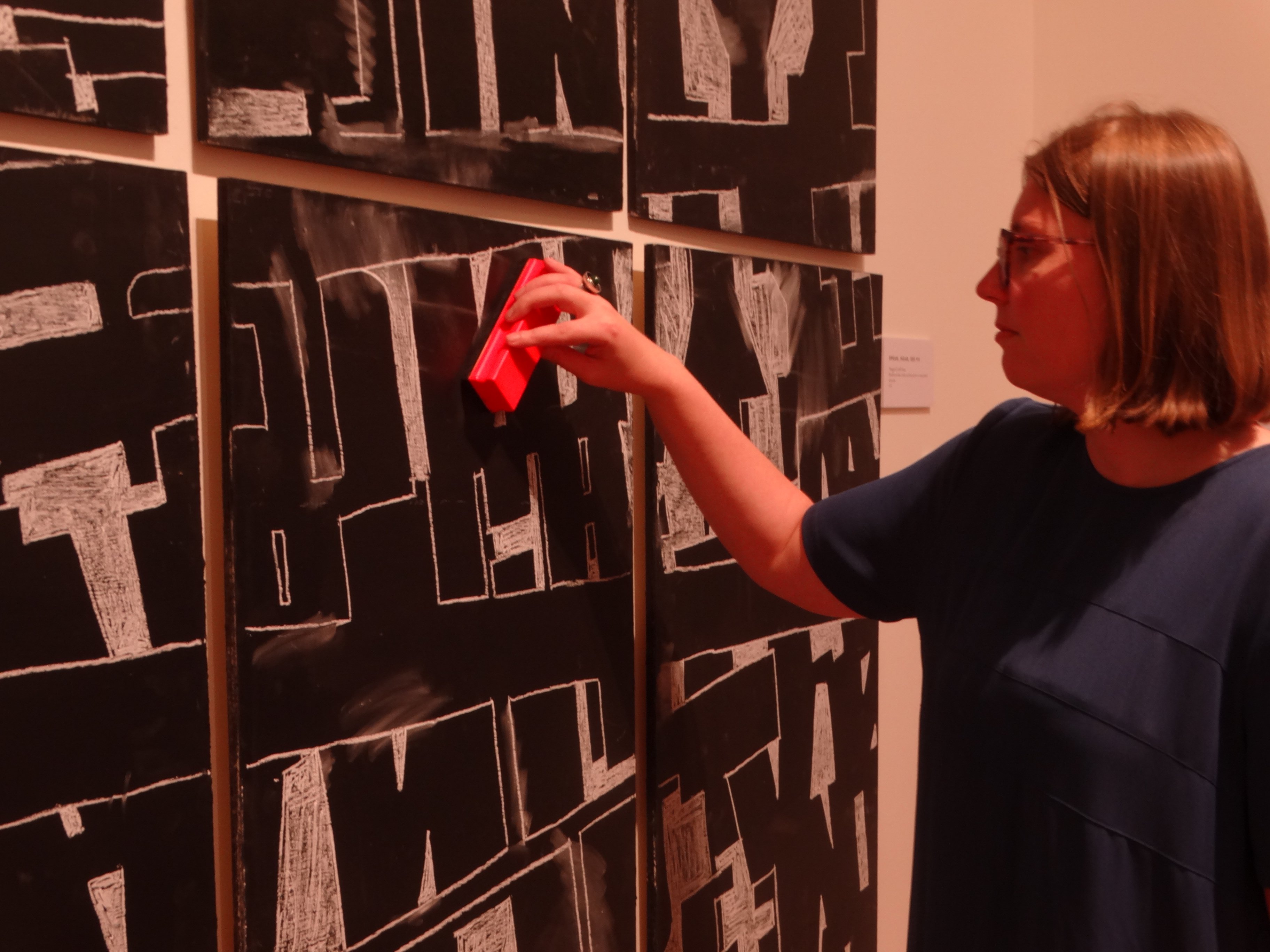 Forrester Gallery director Chloe Searle has a go at erasing artwork from a chalkboard that is...