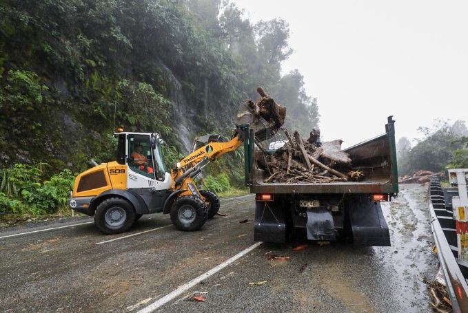 Crews clearing a slip on State Highway 6 near Franz Josef. Photo: RNZ