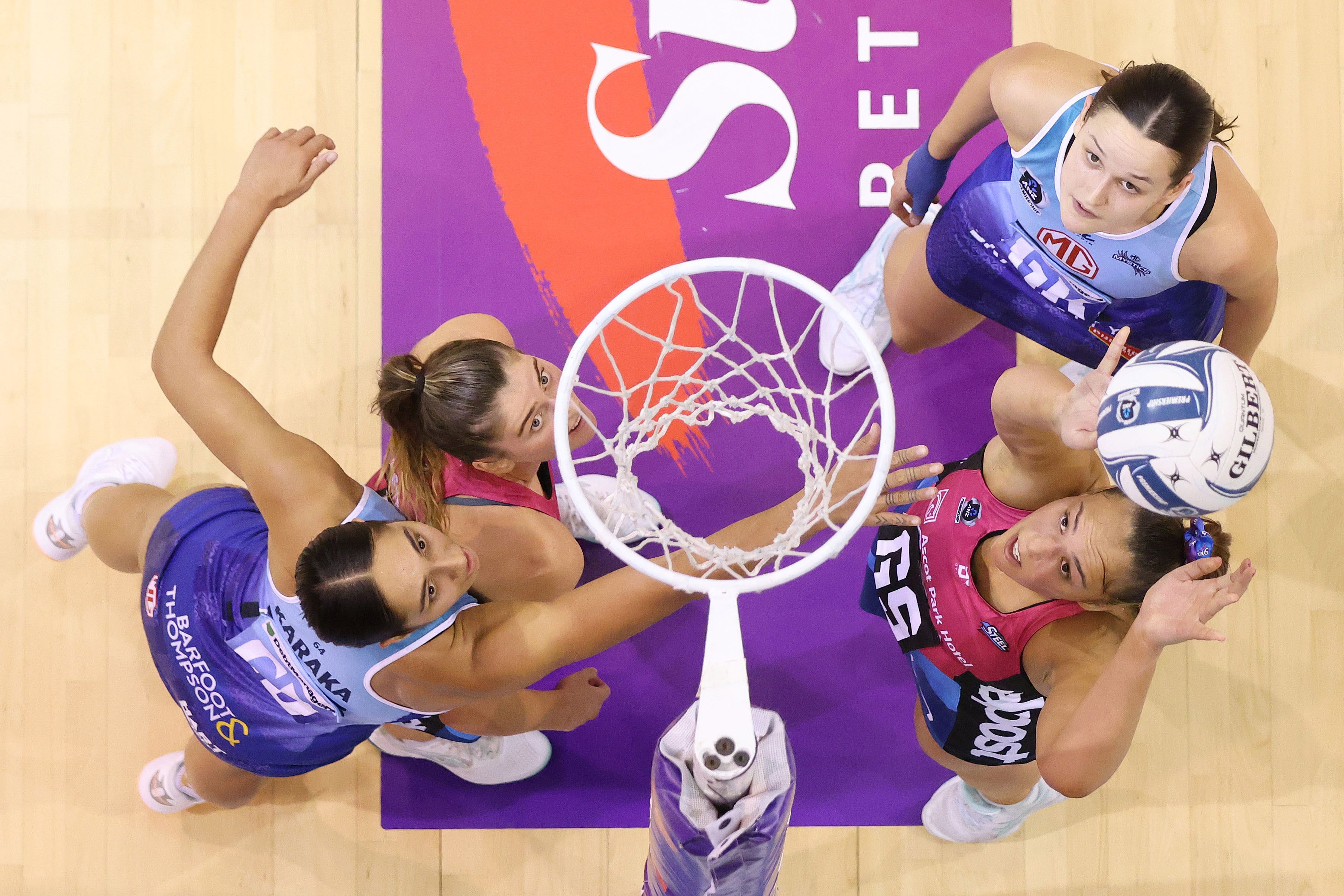 Southern Steel shooter Grace Namana takes a shot under the pressure of Mystics defender Phoenix...