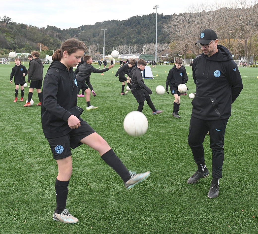 Dunedin City Royals Academy director-coach Blair Scoullar watches Charlotte Evans, 11, as she...
