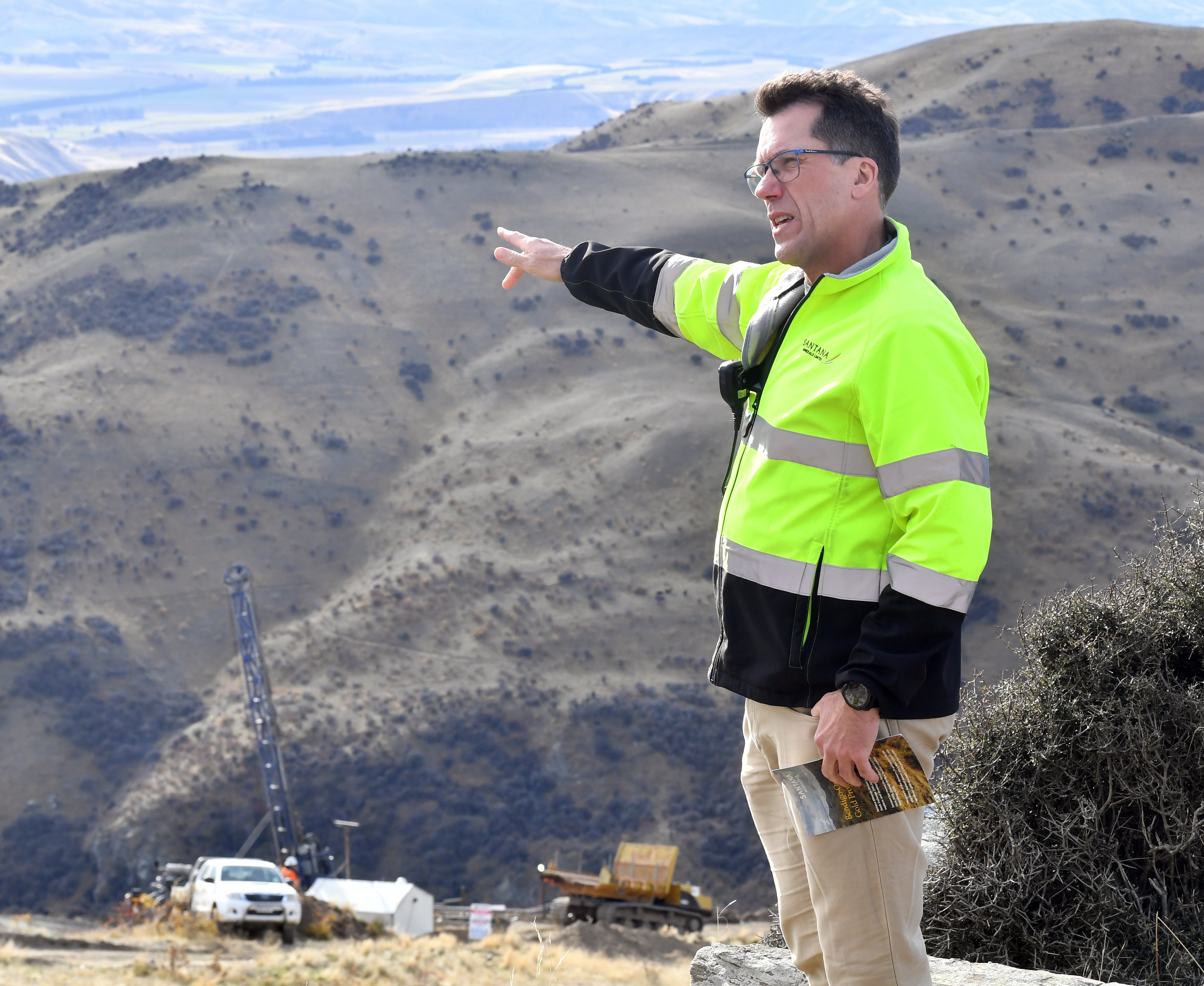 Santana Minerals Ltd chief executive Damian Spring motions towards the Central Otago landscape...