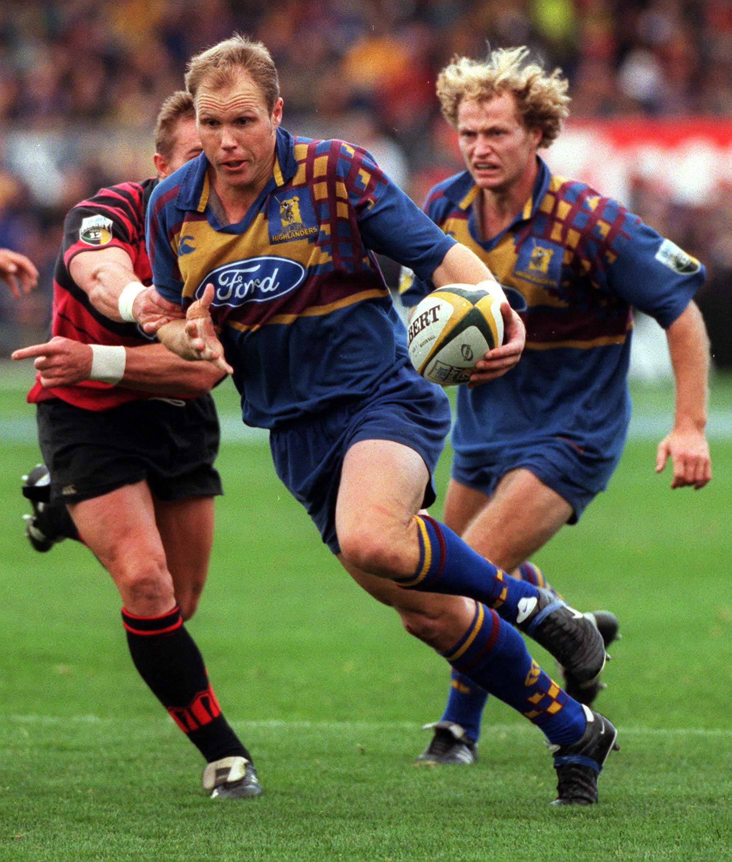 Highlanders fullback Jeff Wilson has Tony Brown in support as he makes a break against the...