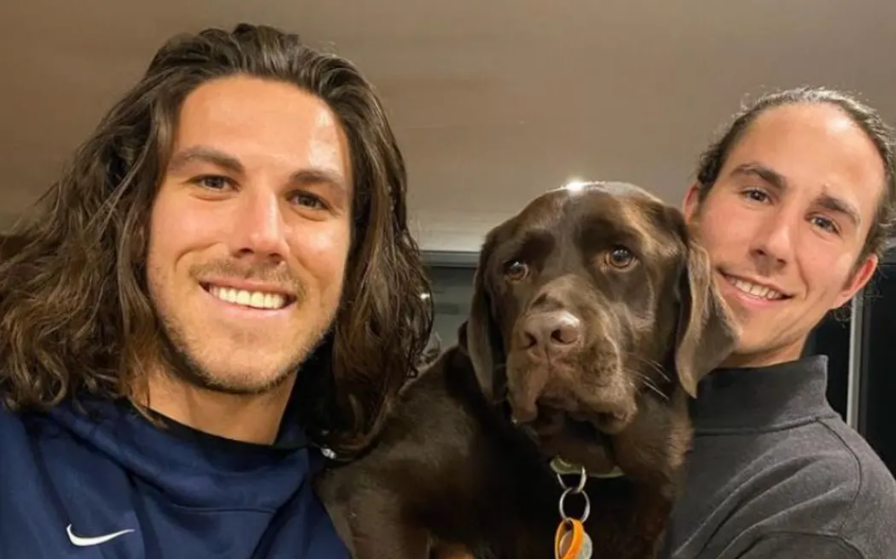 Callum, left, and Jake Robinson with their family dog. Photo: Instagram/Supplied