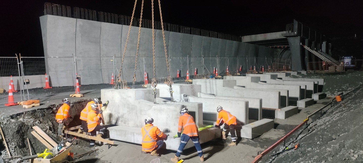 Workers assemble 165 pre-cast concrete modules on site like giant Lego.