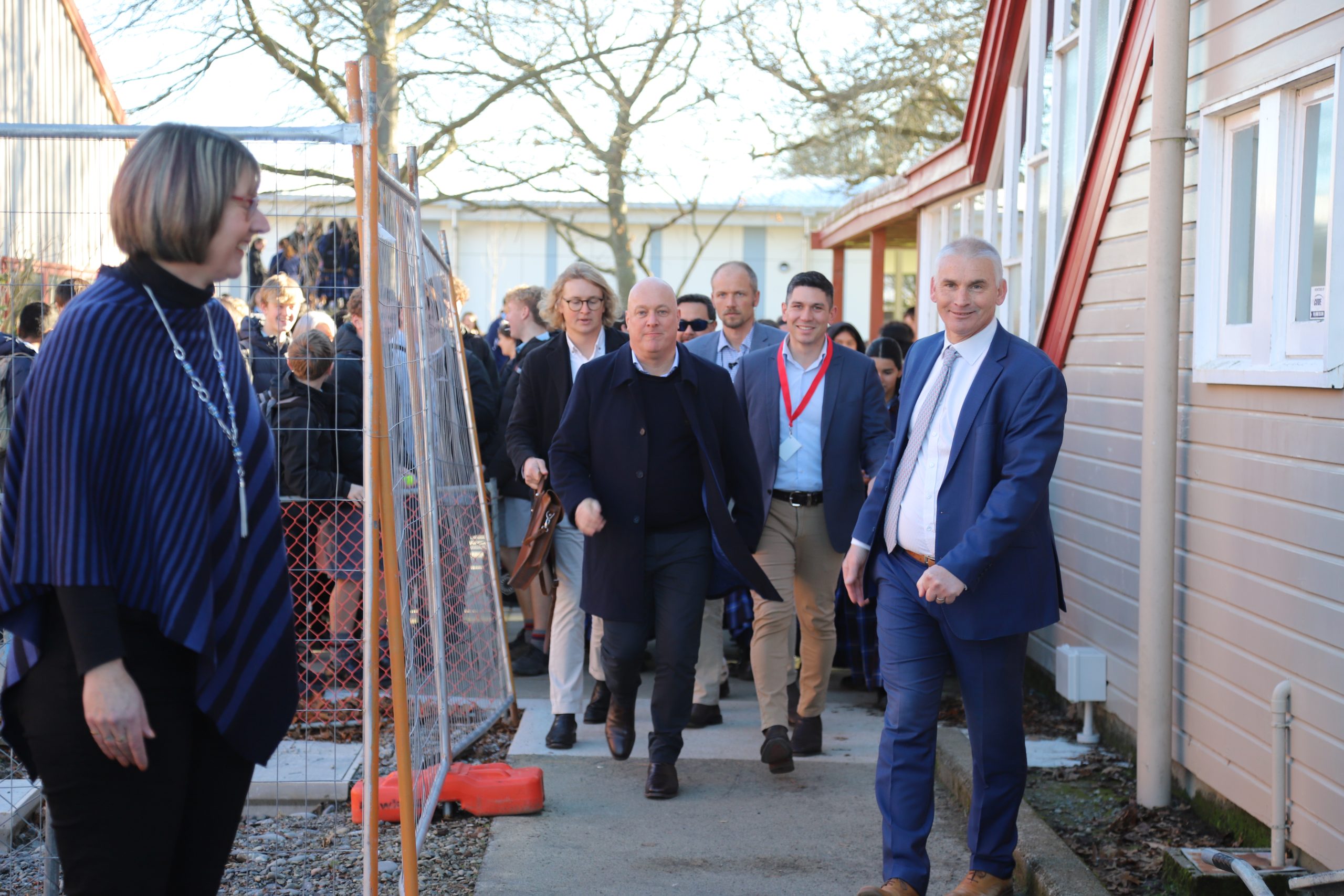 Prime Minister Christopher Luxon (centre) ran the gauntlet of excited teenagers on his walk-about...