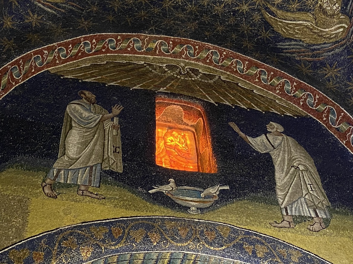 The interior of Mausoleum of Galla Placidia showing the sun glowing through alabaster windows. 