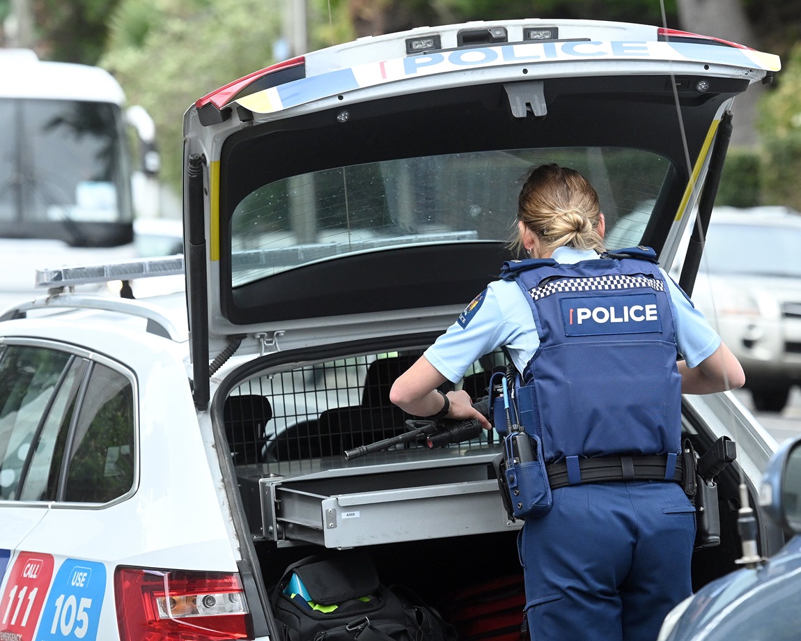 A police officer returns her weapon to a patrol car following an incident in Crown St, North East...