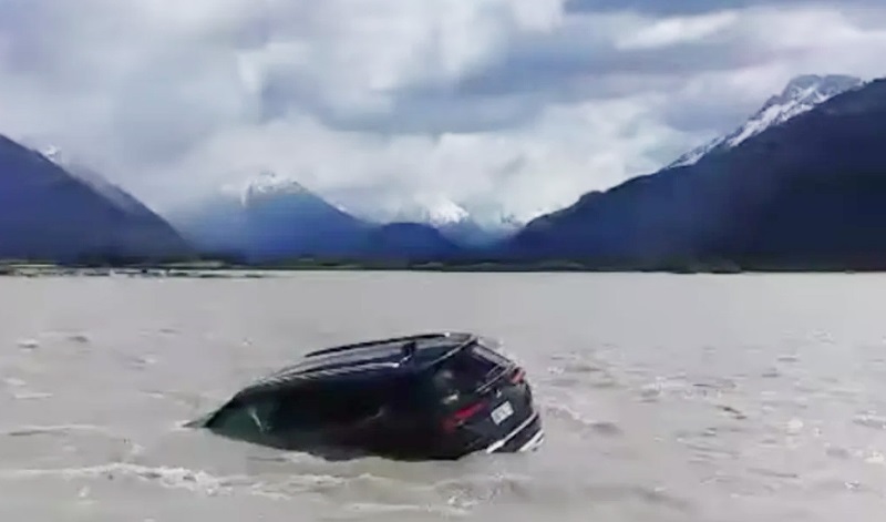 A tourist’s SUV in the Dart River, near Kinloch, after being swept off the river bank on Saturday...