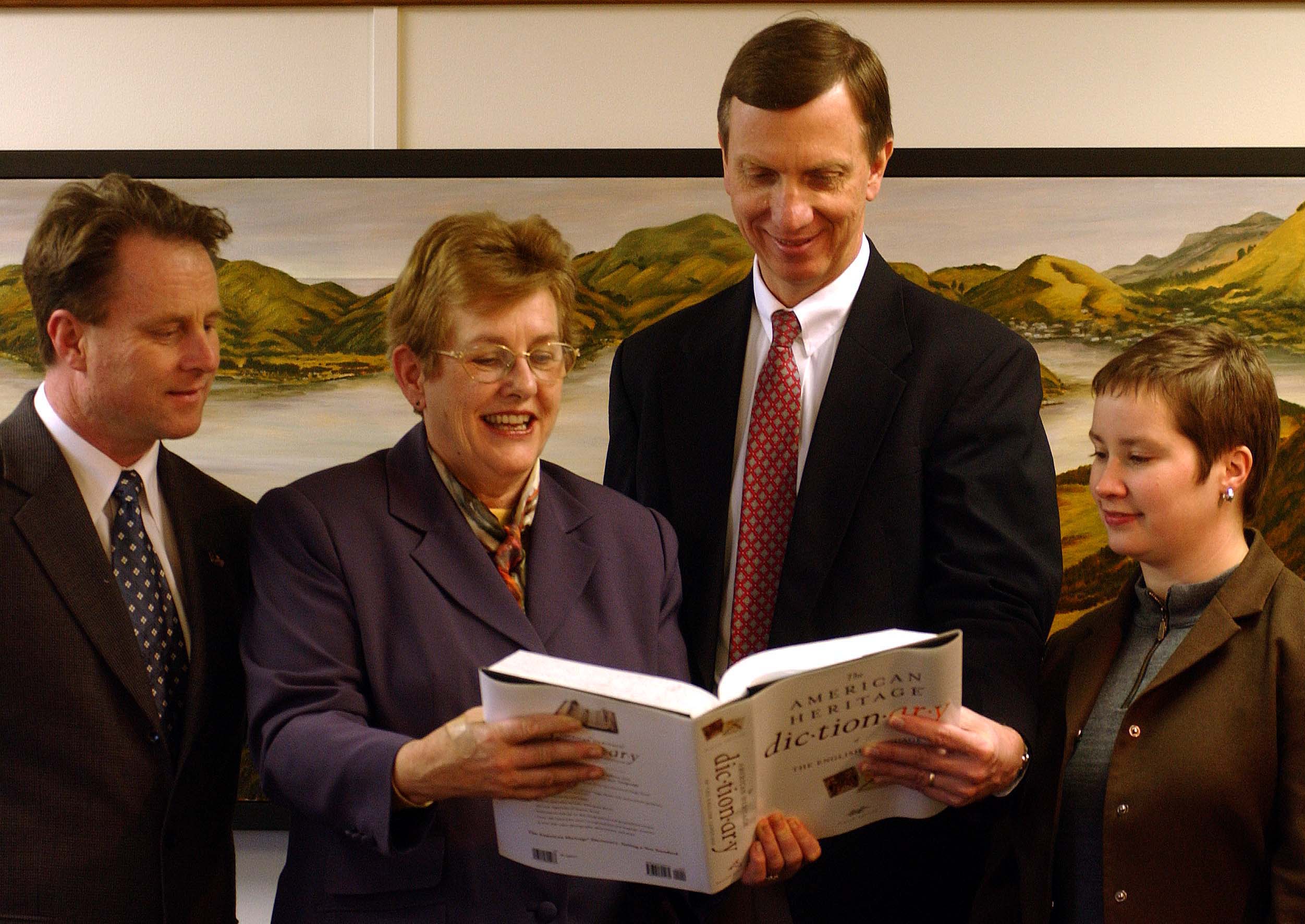 Dame Elizabeth Hanan reads from a book given to the city by visiting United States Embassy public...