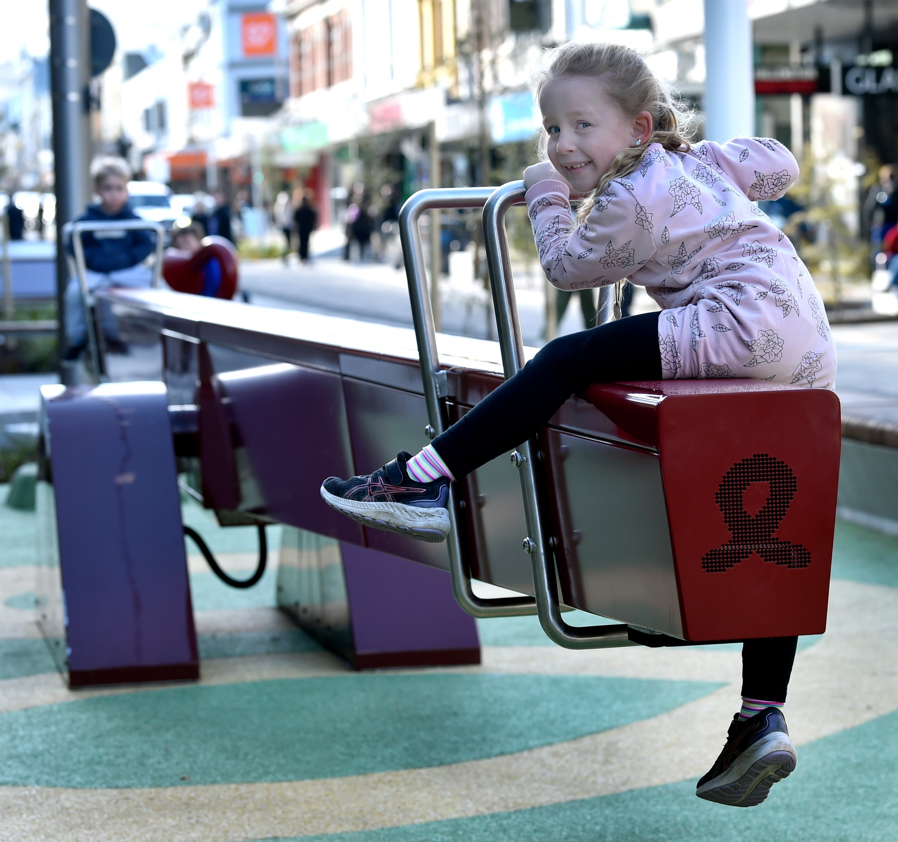 Siblings Addison, 5, and Jaylen, 3, Mclean, of Balfour, try out the seesaw at the George St...