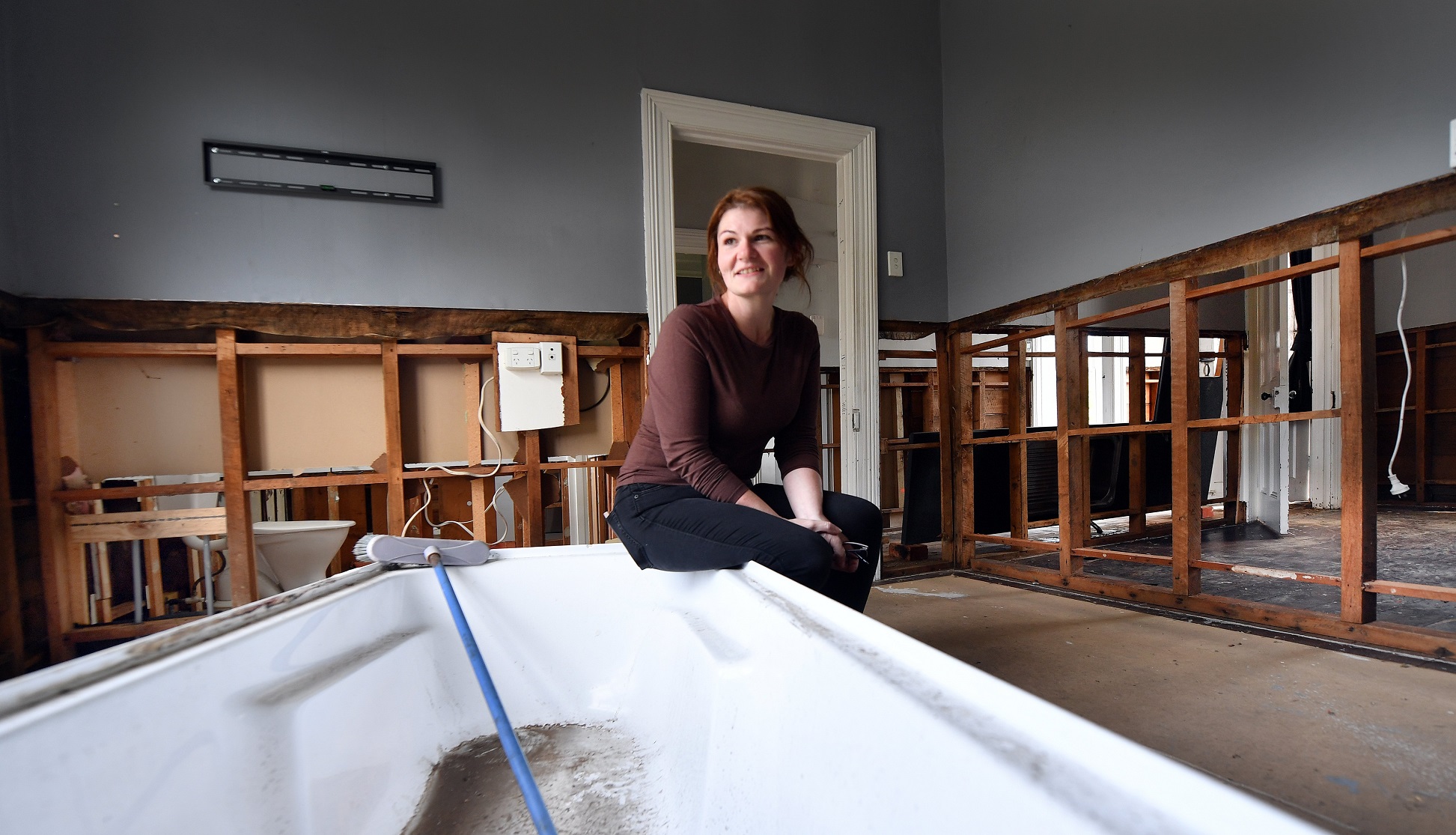 Brianna Soper sits in the living room of her Surrey St home which was rendered unlivable in the...