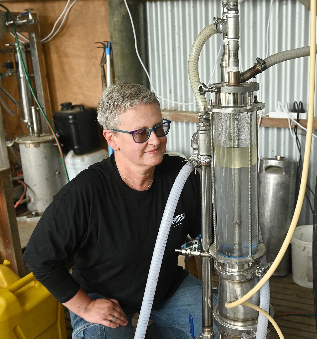 Lavender Row owner Paula Cosgrove watches oil collect during the distillation process.