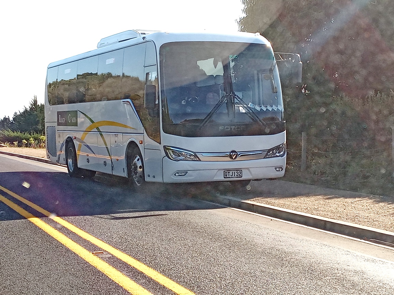 A Reach Coach charter bus parked on the side of Blackhead Rd, by the double yellow lines. Photo:...