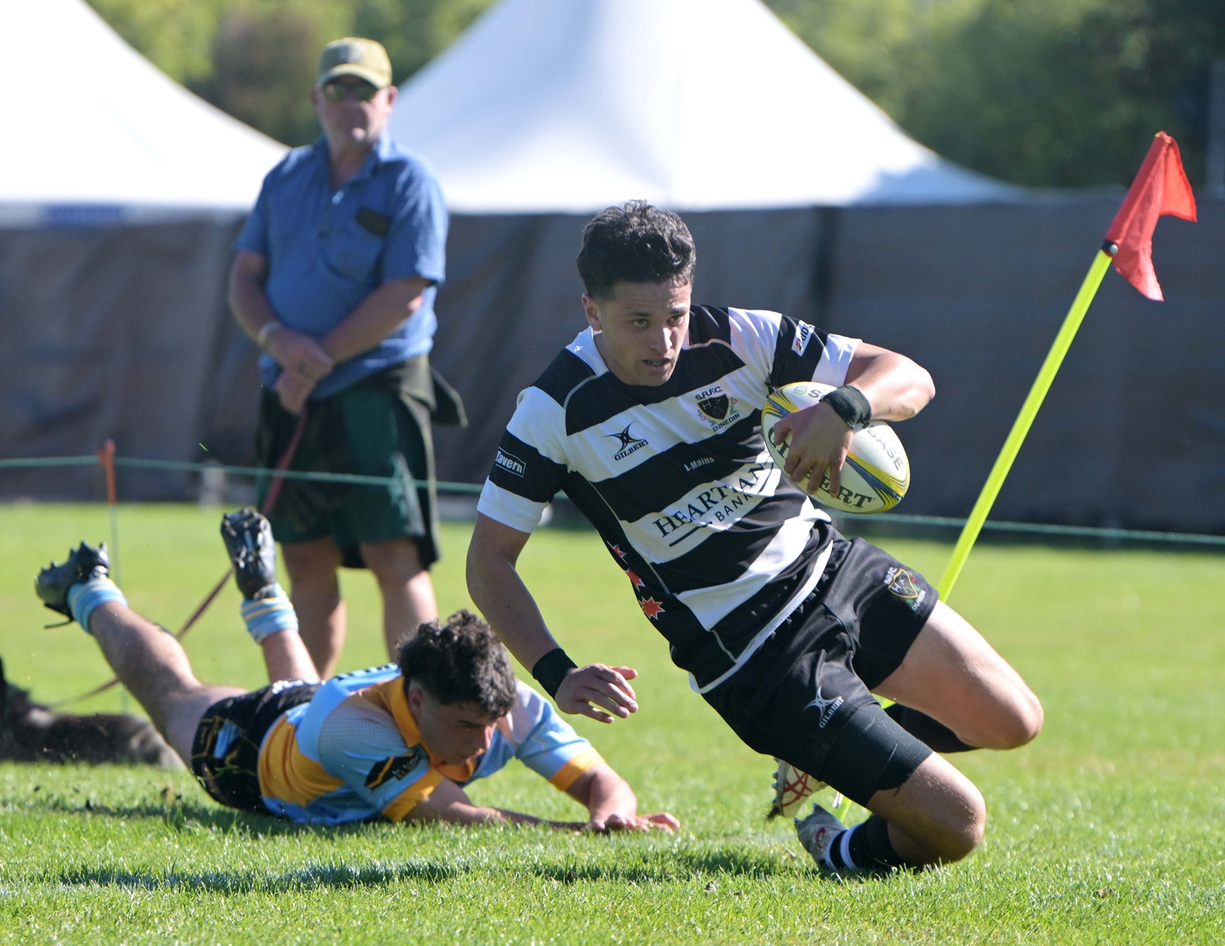 Southern fullback Levi Emery beats the tackle of University wing Josh Dent to score.