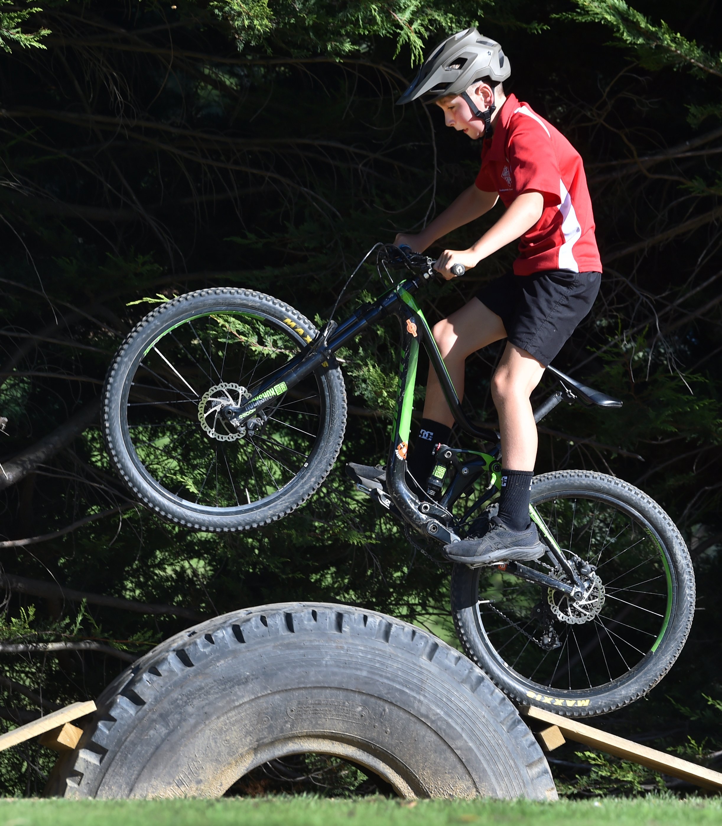 Fairfield School year 5 pupil Hopper Cain, 9, pops a wheelie over a tyre feature on his school’s...