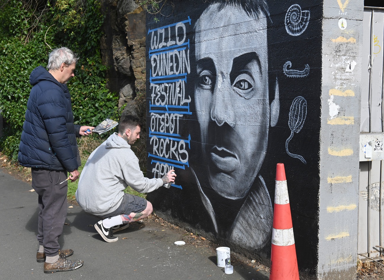Dunedin artist Bruce Mahalski (left) and Mason Stephens put the finishing touches to a mural of...