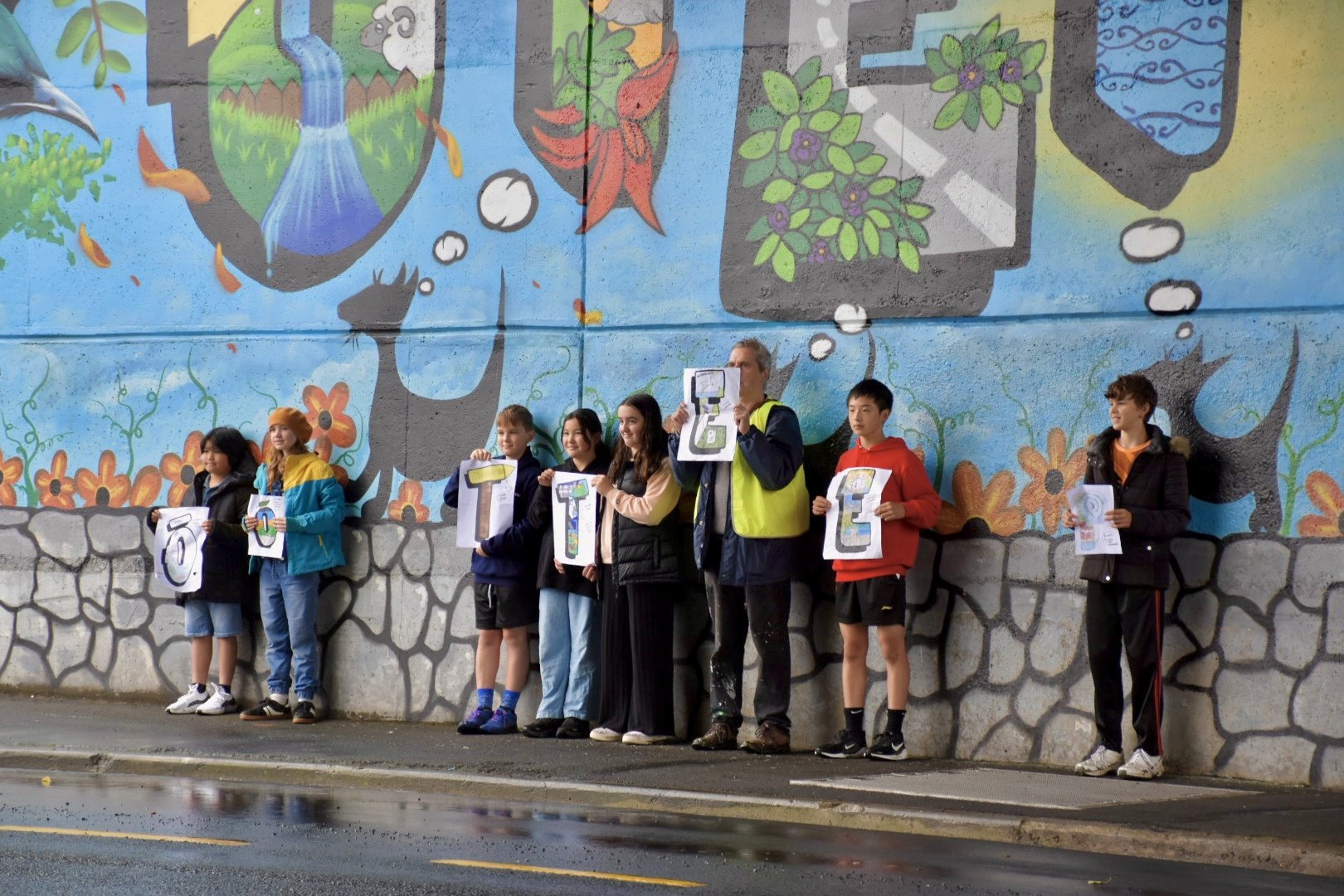 Local school children stand with project manager Bruce Mahalski in front of the newly completed...