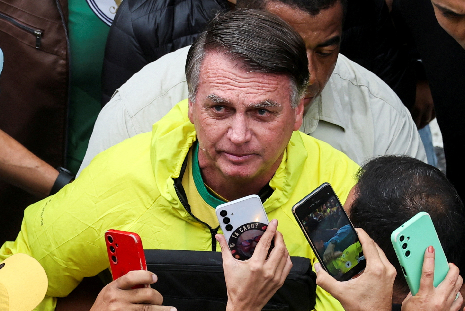 Former Brazilian president Jair Bolsonaro looks up as he greets his supporters, at a...