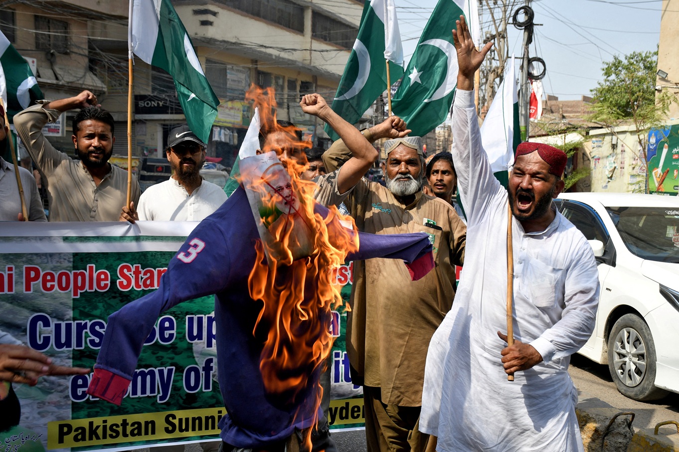 Demonstrators burn an effigy during an anti-India protest in Hyderabad following India's military...