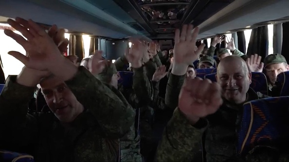 A screen capture from a video shows 307 Russian servicemen in captivity being returned while 307...