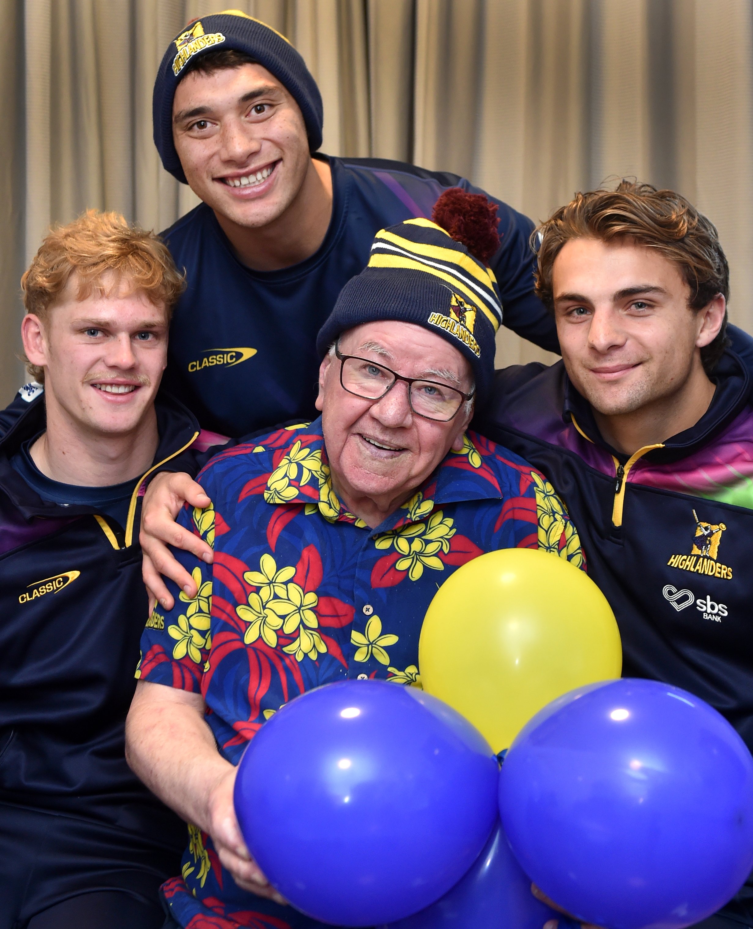 Highlanders (from left) Finn Hurley, Thomas Umaga-Jensen and James Arscott visit superfan Dennis...