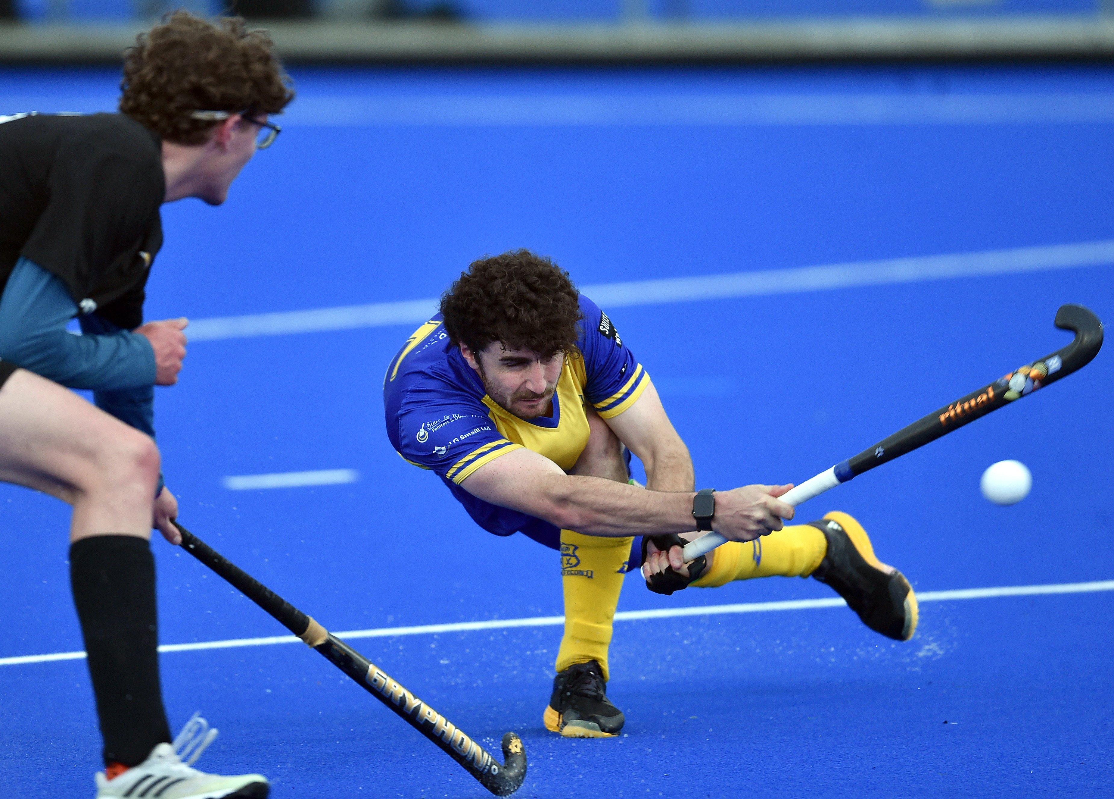 Taieri Tuataras player James Nicolson gives it a good whack while watched by University Panthers...