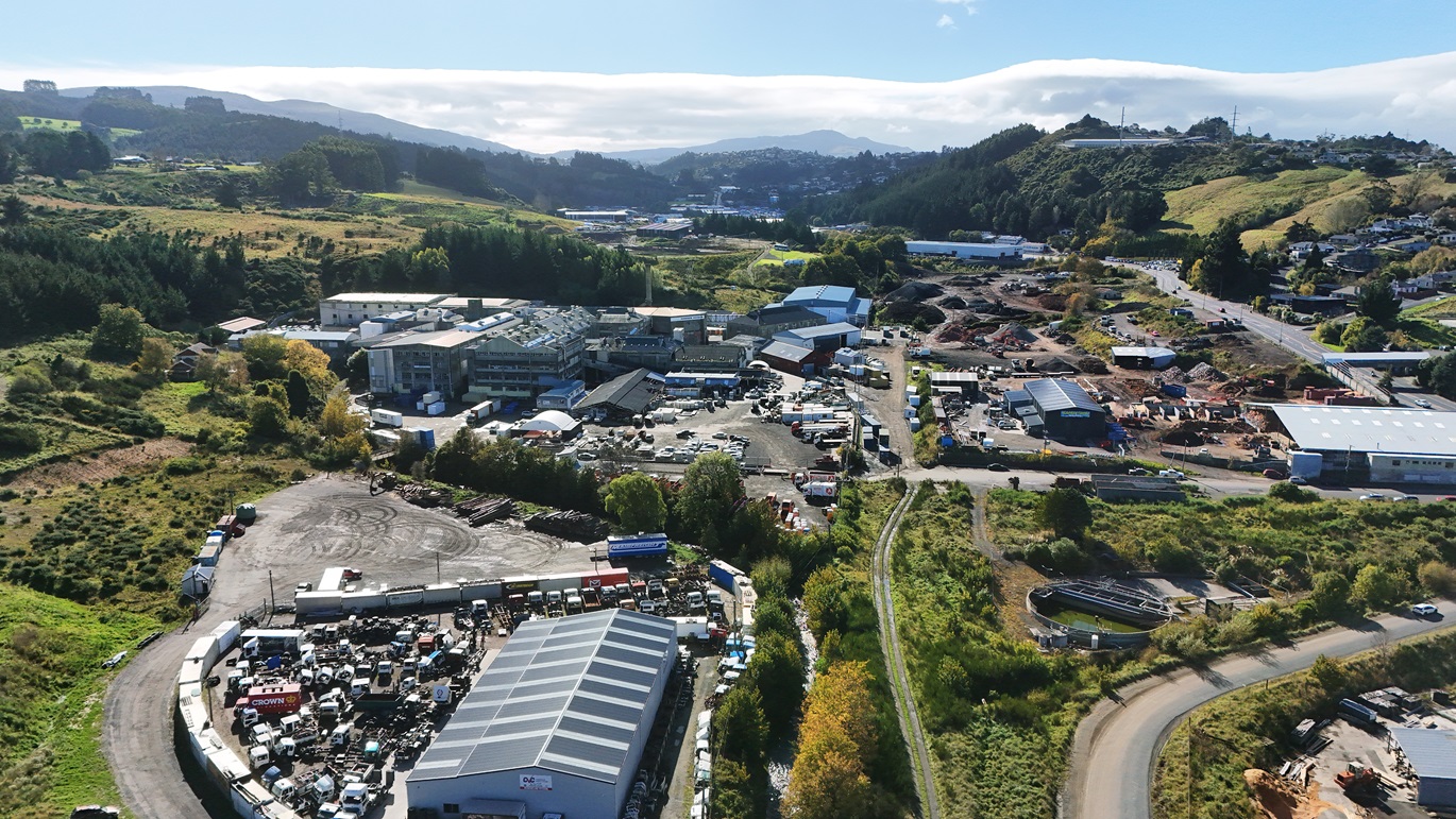 The Kaikorai stream emerges, bottom centre, from Kaikorai Valley, under and around industrial...