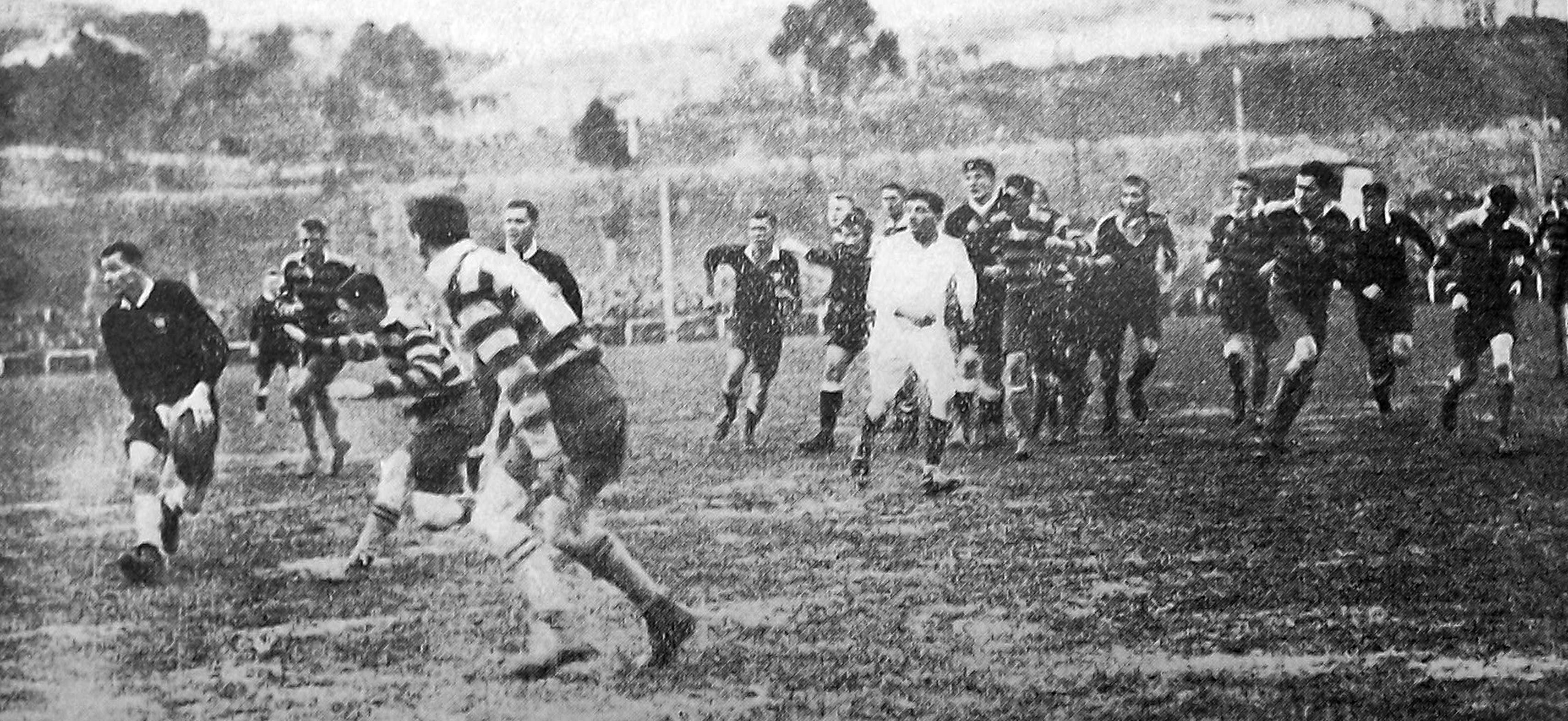 A New Zealand University player (left) about to unload during the team’s rugby match against...
