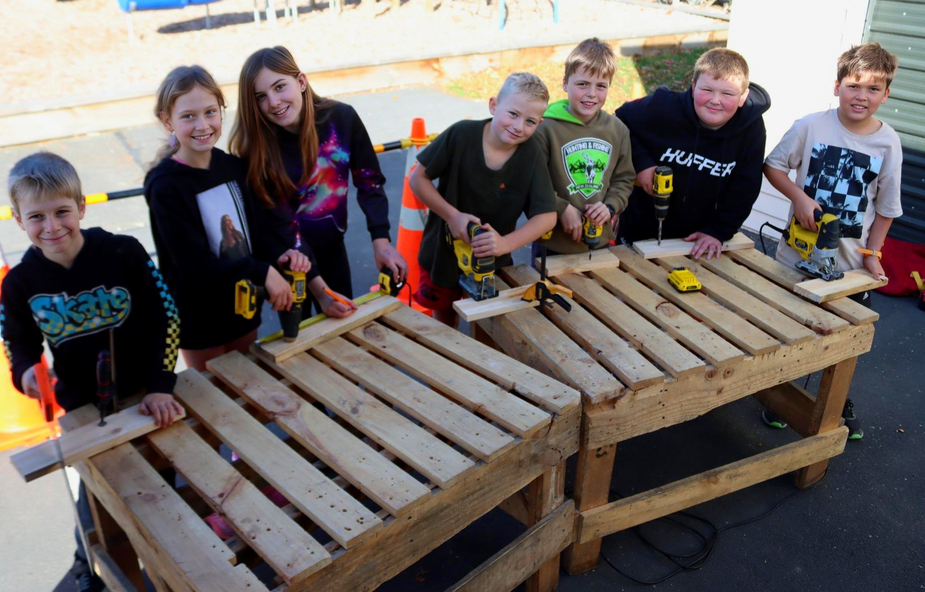 Learning how to safely operate carpentry equipment are Outram School pupils (from left) Liam...