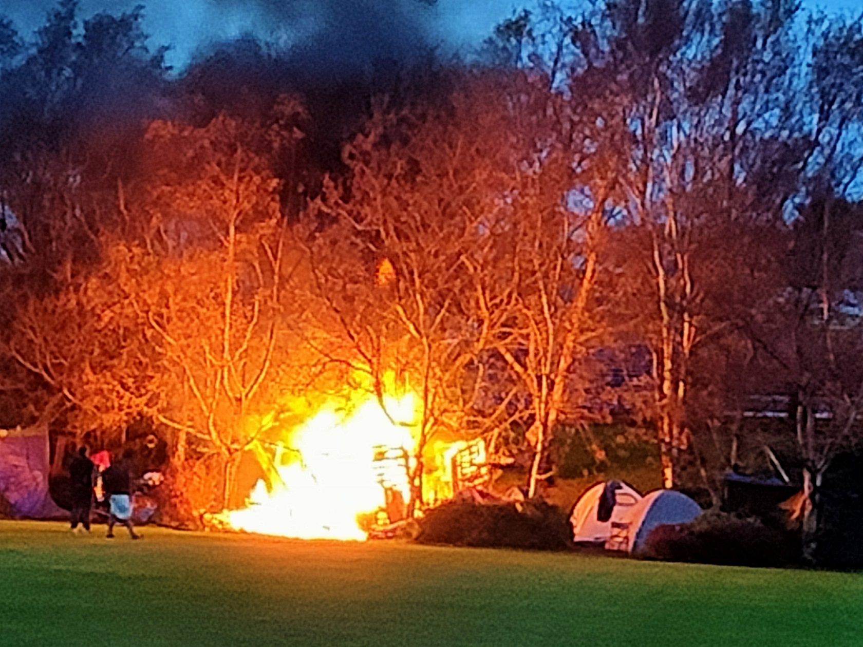 A fire roars in the makeshift shelter. Photo: Brett Dixon
