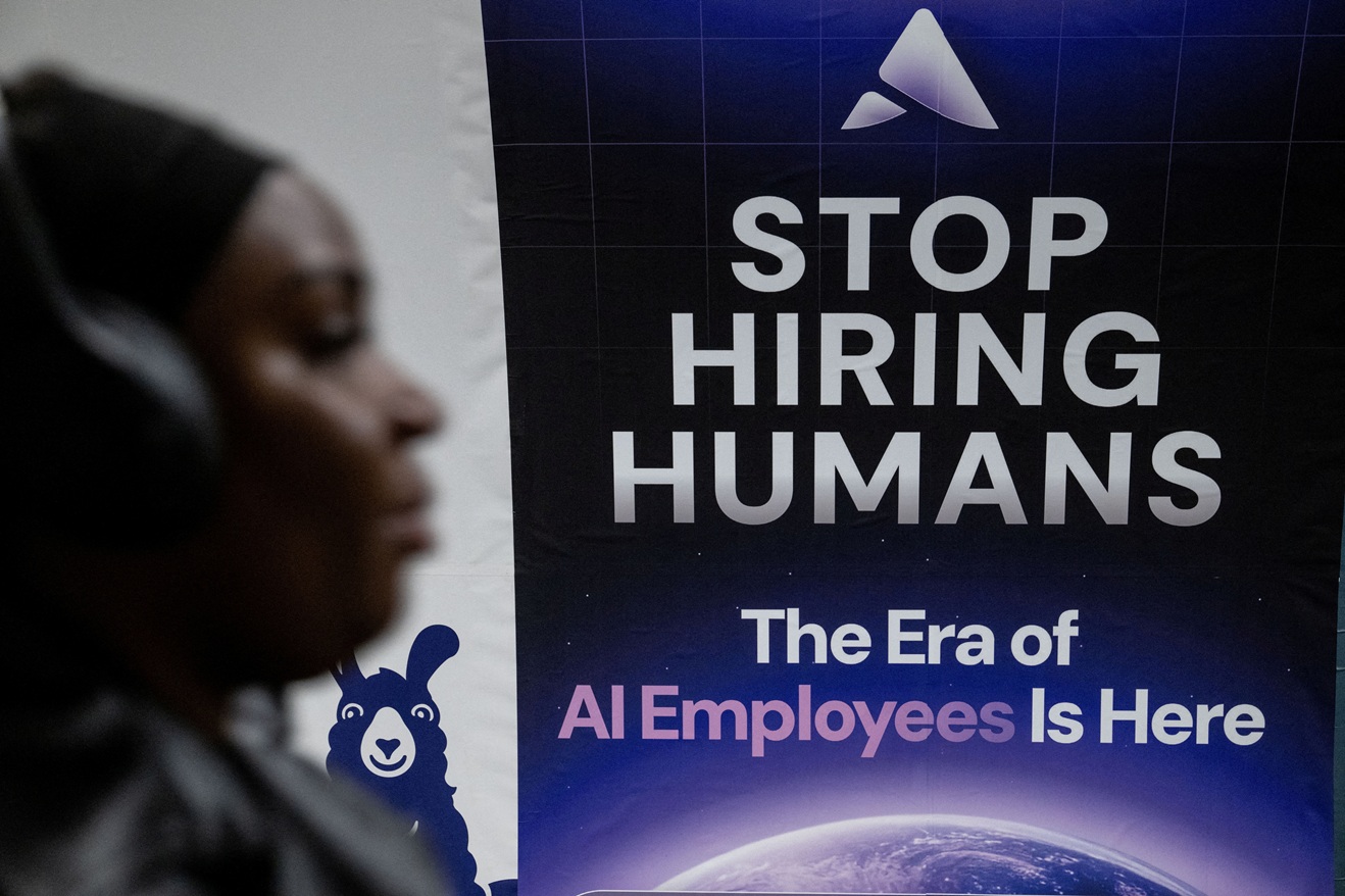 A person passes a billboard for an Artificial Intelligence company on an underground station...