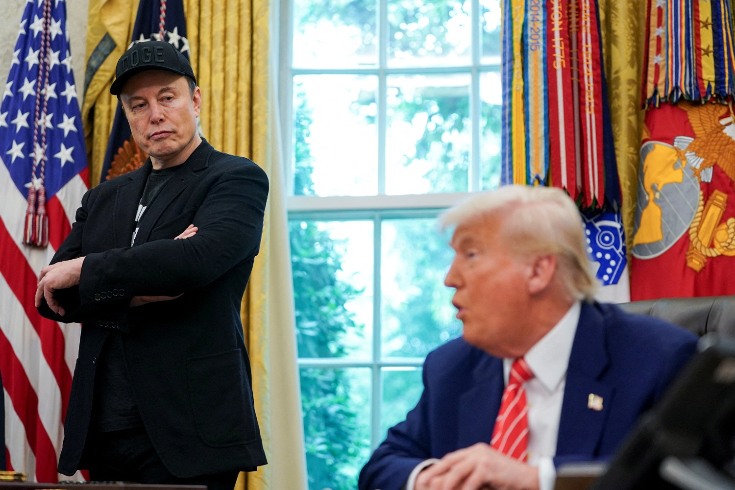 Elon Musk (L) and US President Donald Trump attend a press conference in the Oval Office of the...