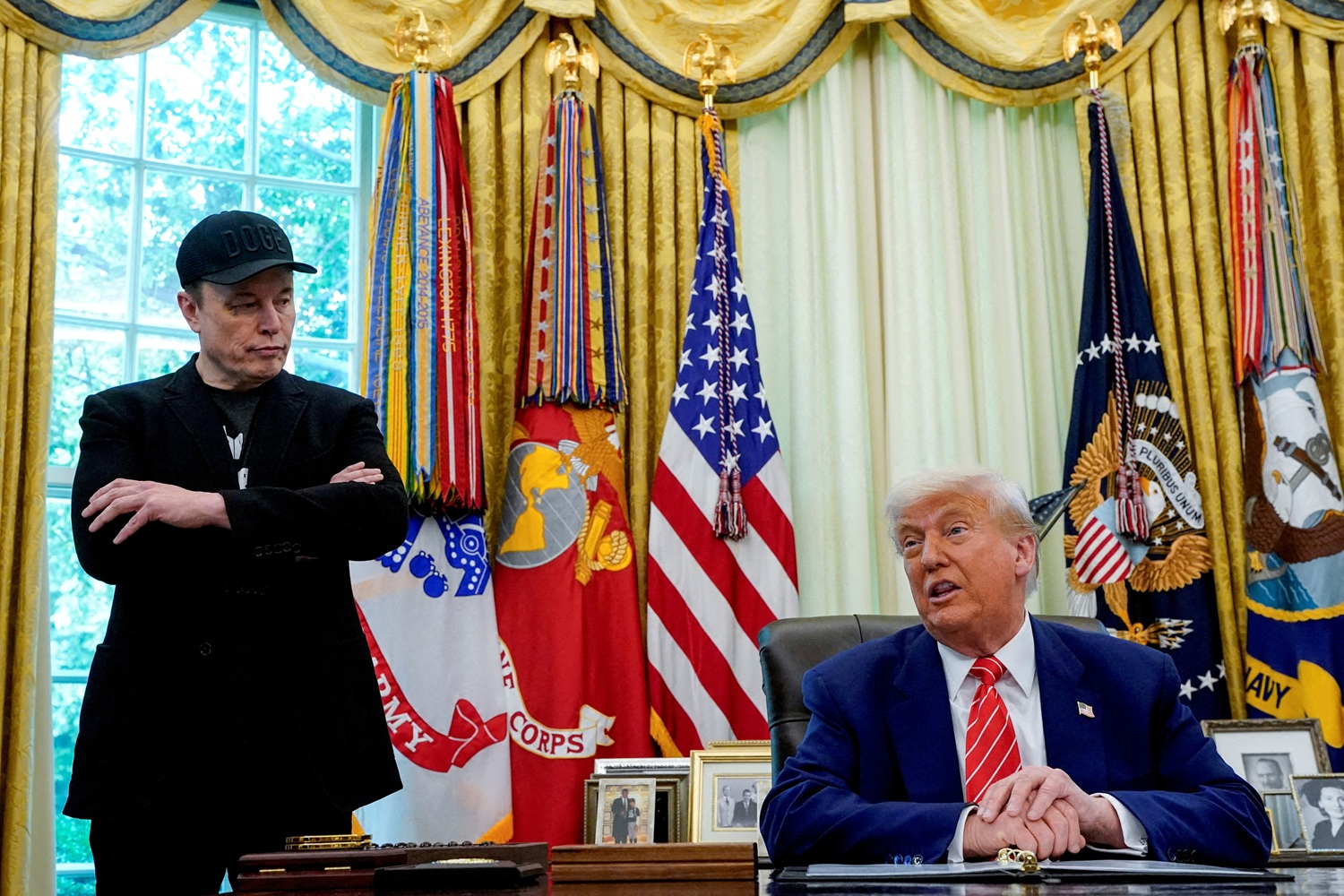 Elon Musk and US President Donald Trump at a press conference in the Oval Office of the White...