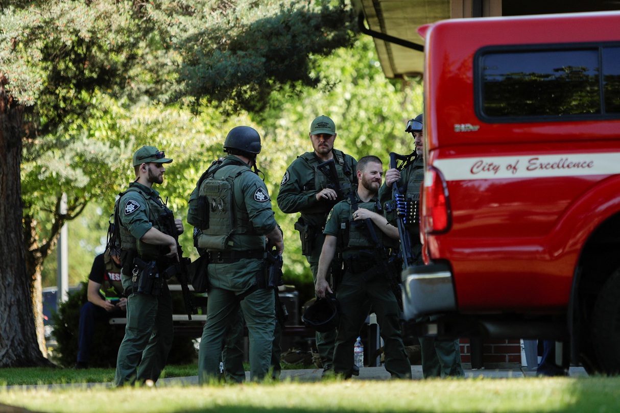 Armed law enforcement officers respond to the incident at Cherry Hill Park outside Coeur d’Alene,...