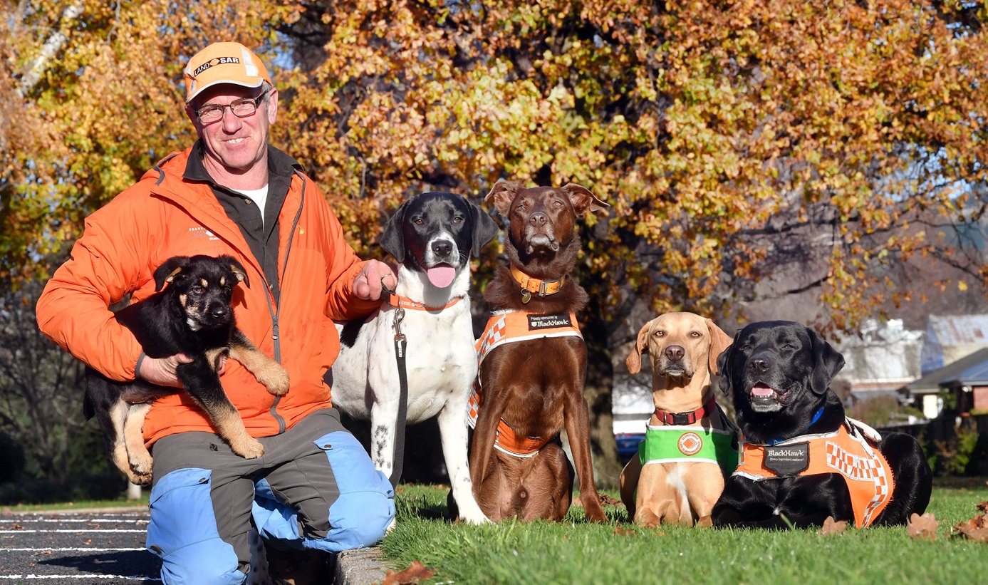 LandSAR dog handler Barry Dougherty relaxes in Dunedin with his family of dogs (from left) 19...